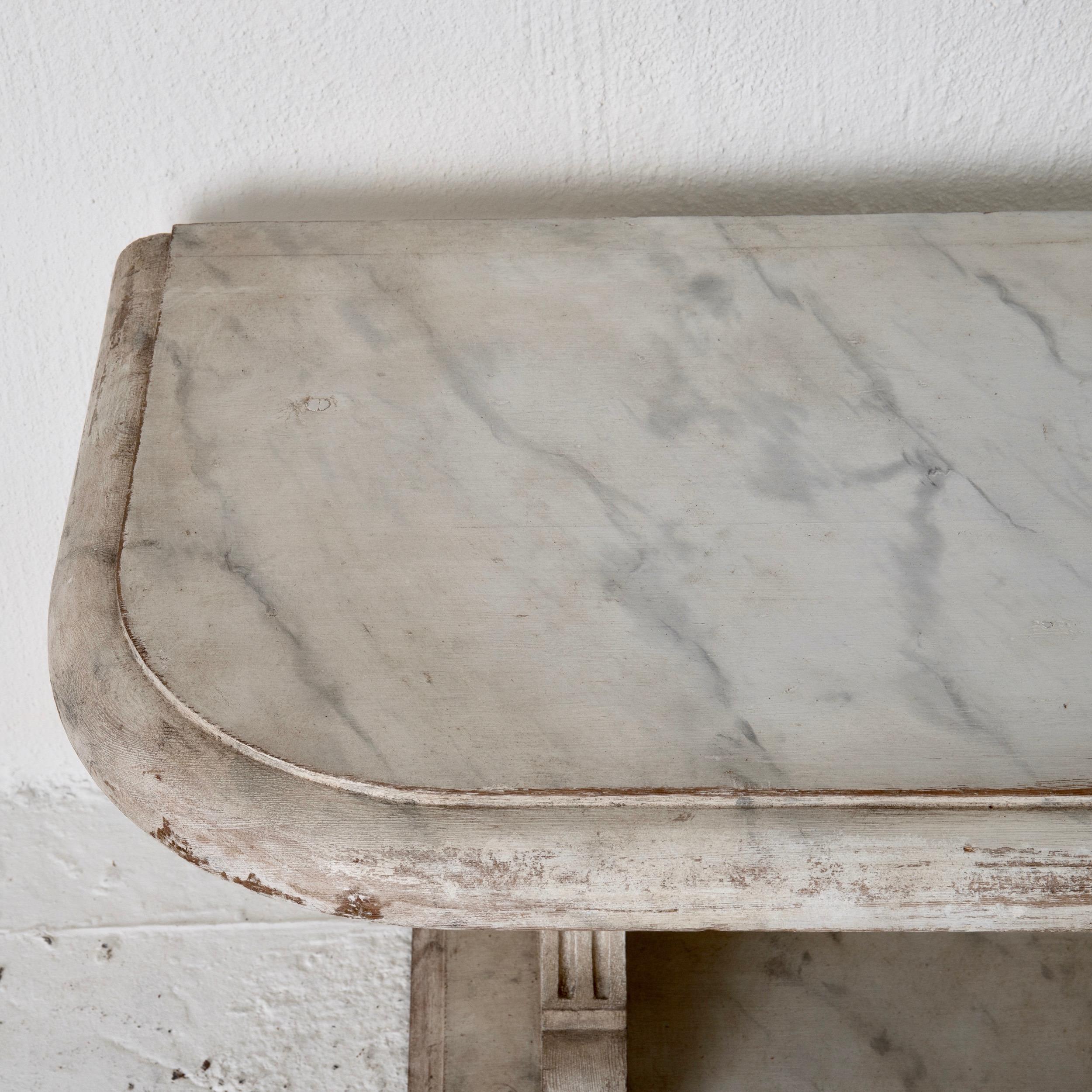 Bench console Swedish 18th century faux marble paint, Sweden. A bench made during the 18th century in Sweden. Painted later in a faux marble pattern. Rectangular shape with rounded corners. Channeled details on sides.
 
  