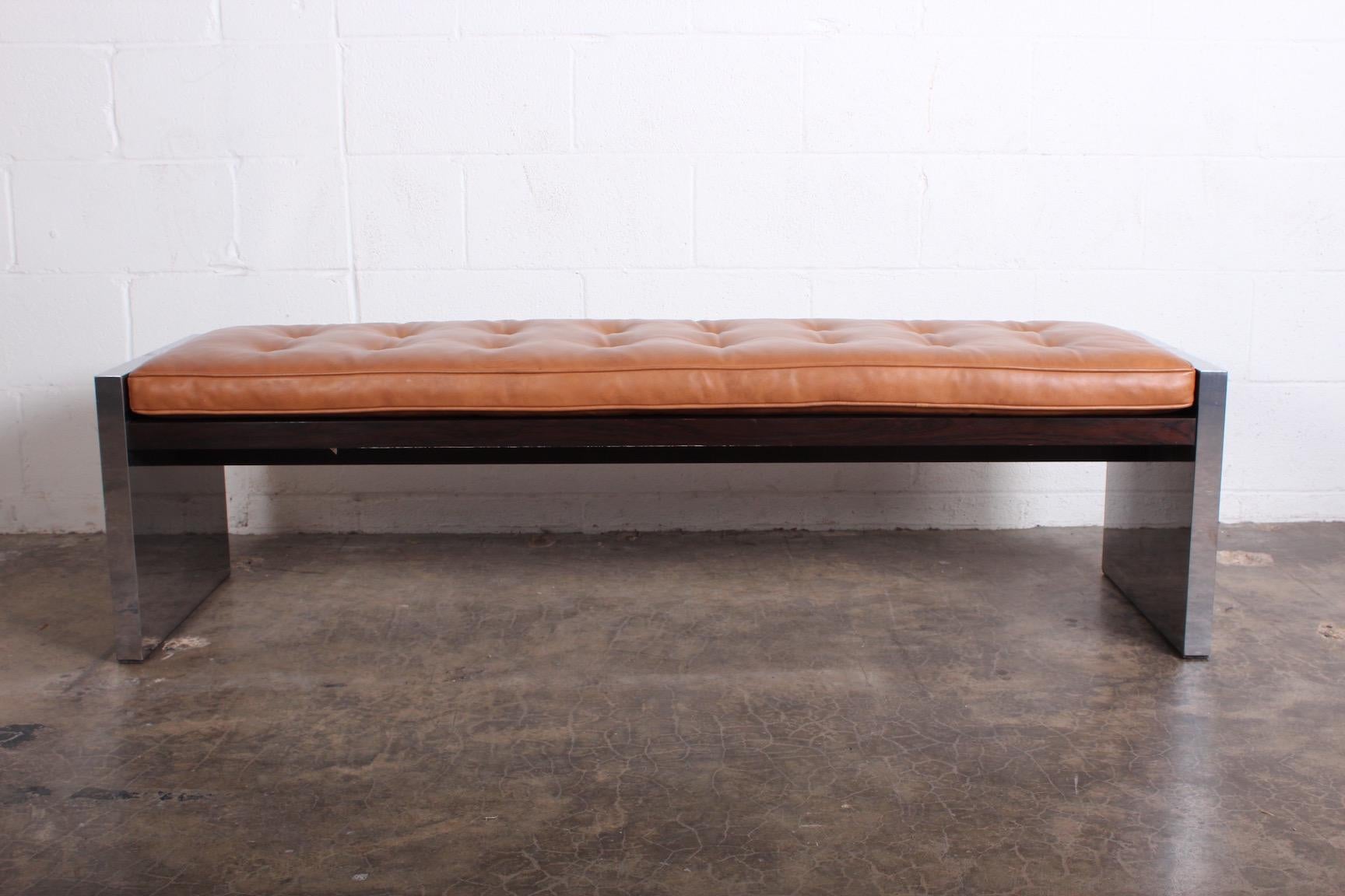 A bench designed by Roger Sprunger for Dunbar in polished stainless steel, rosewood and original leather.