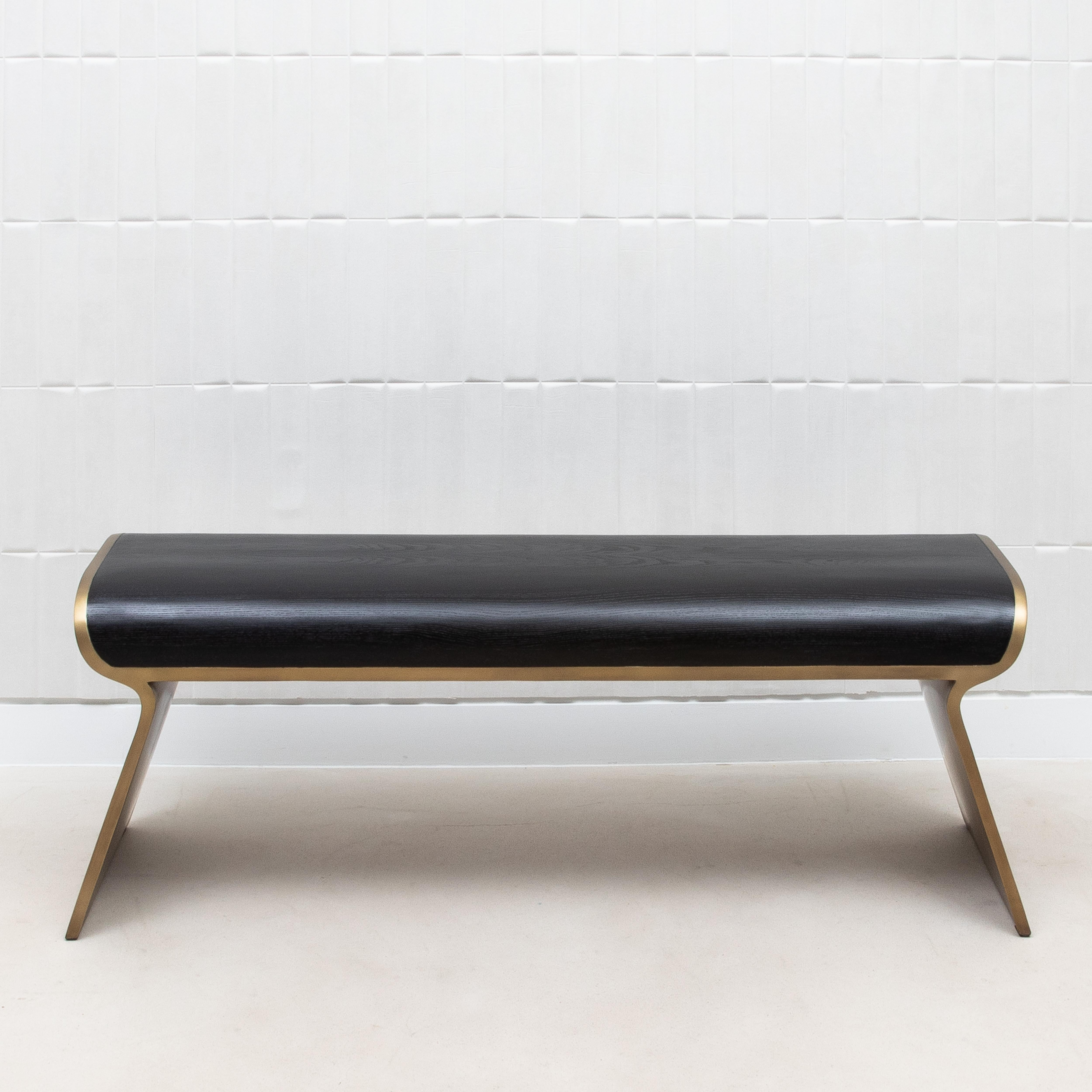 The Dandy Day Bench by Kifu Paris, crafted in luxurious black oak and accented with bronze patina brass, is a striking embodiment of modern elegance. The rich, dark grain of the black oak surface is meticulously hand-finished, offering a subtle yet