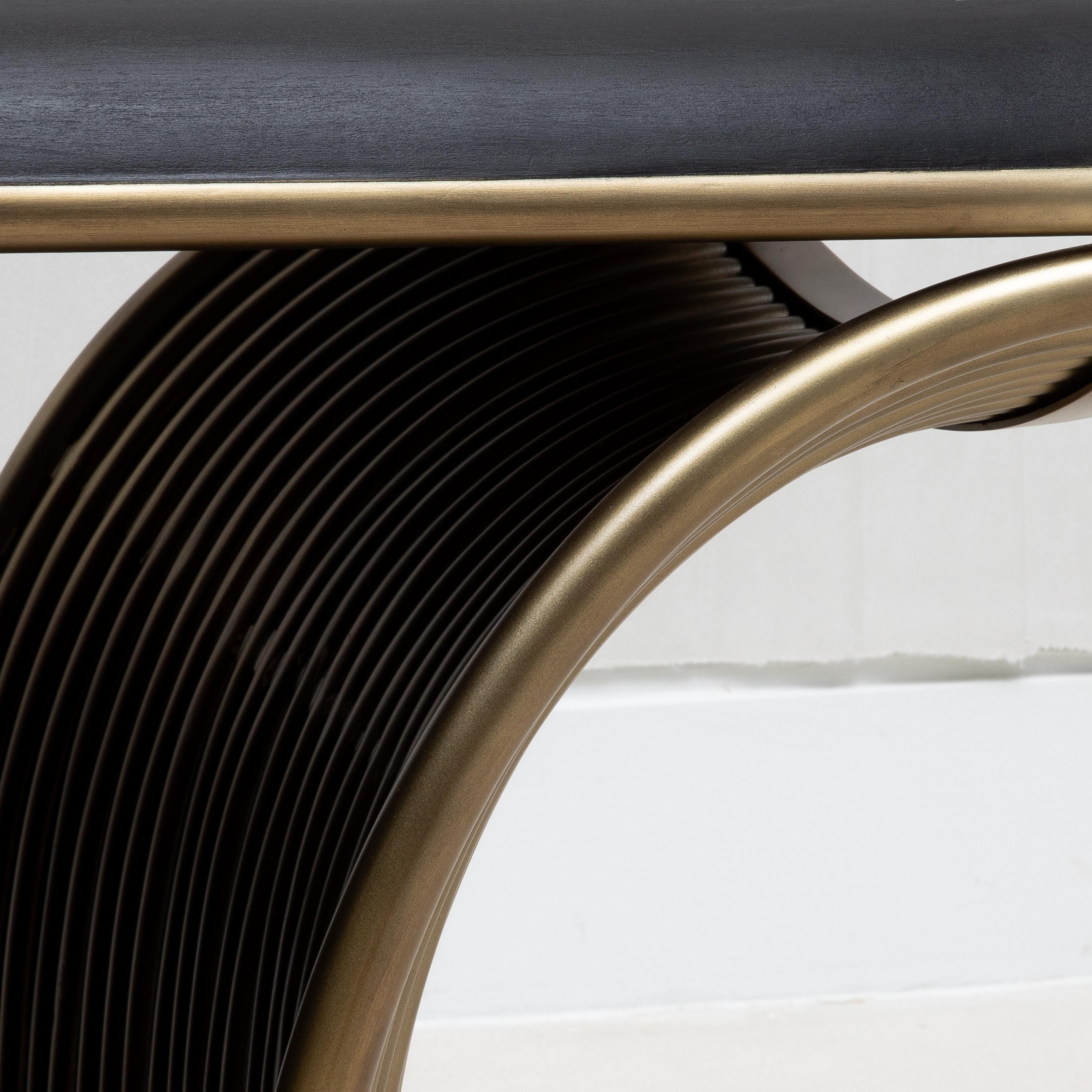 The Nymphea bench by R&Y Augousti is a breathtaking example of luxurious craftsmanship, combining the richness of black oak with the opulence of bronze patina brass. The black oak seat is sleek and refined, providing a perfect contrast to the