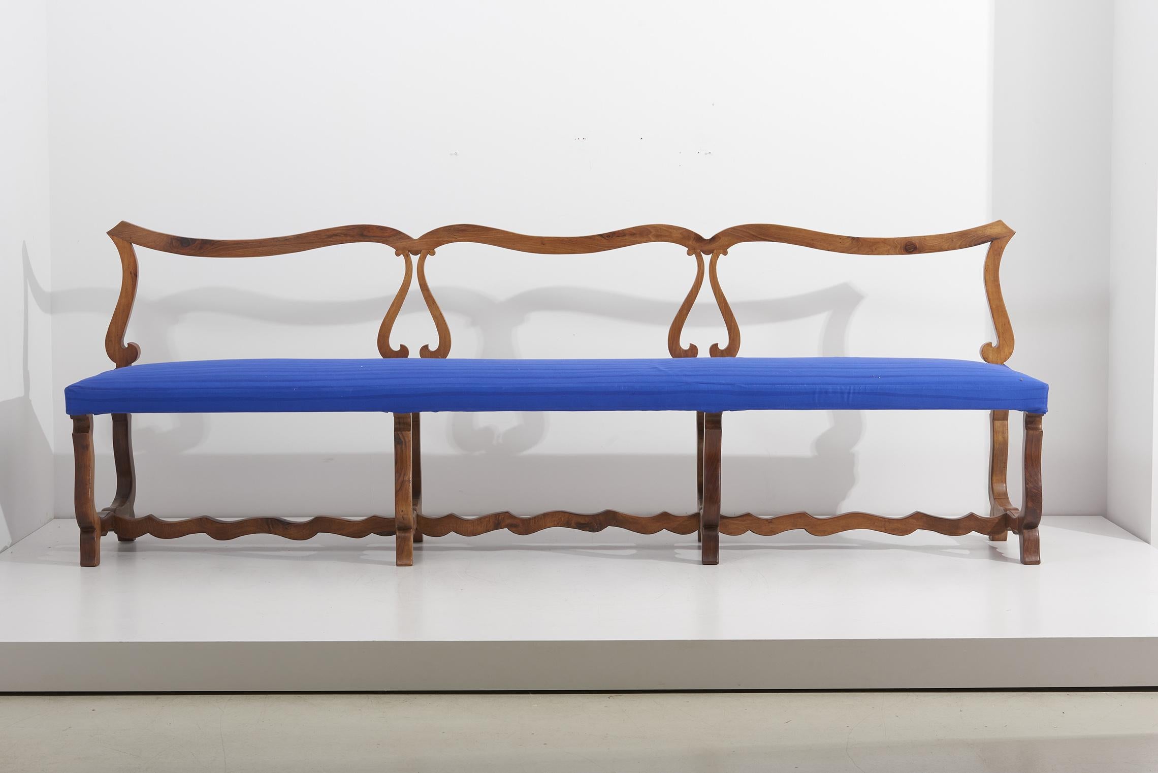 Bench in Spanish walnut and blue Dedar upholstery with hand painted stripes.