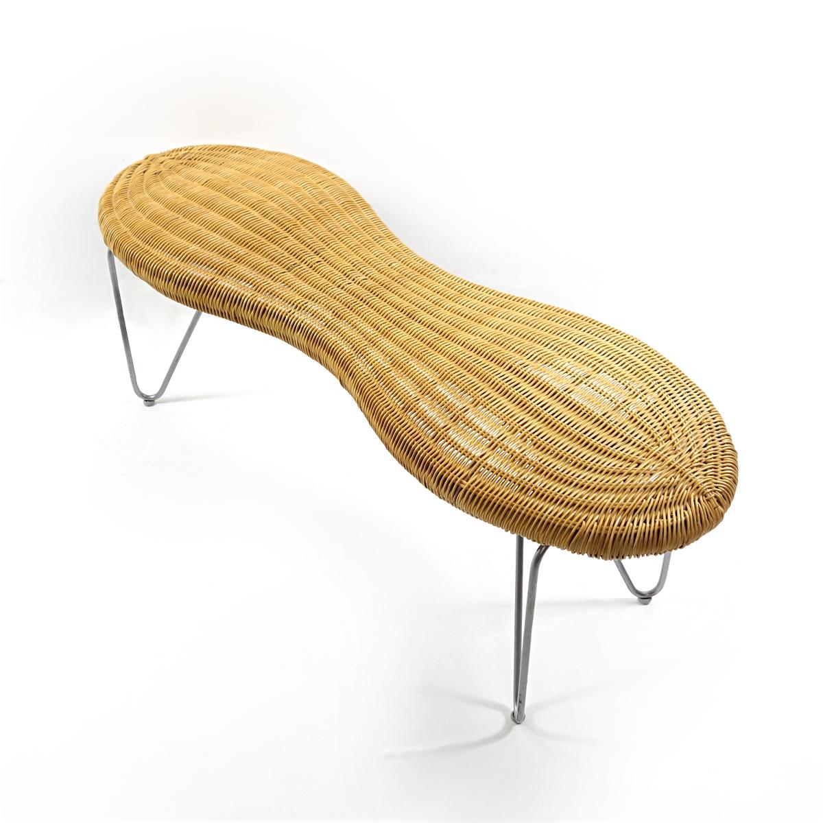 Rattan bench in the shape of a peeling peanut, a limited edition by Ikea from the 1990s. The 3D shapes of the rattan seat have been crafted professionally. The form is elegant due to the characteristic waist of the peanut. Apart from that the