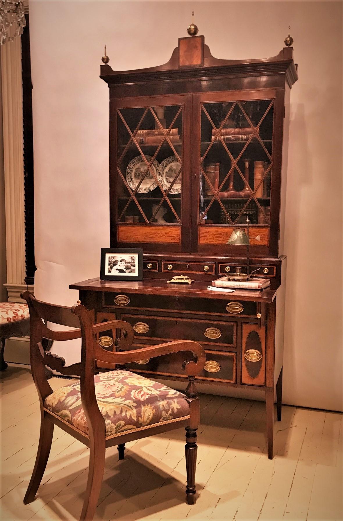This beautiful and elegant piece was probably made around Boston in the early 20th Century. Its design was inspired by late 18th Century New England Hepplewhite styled secretary bookcases. It was handmade by a very skilled cabinetmaker using the