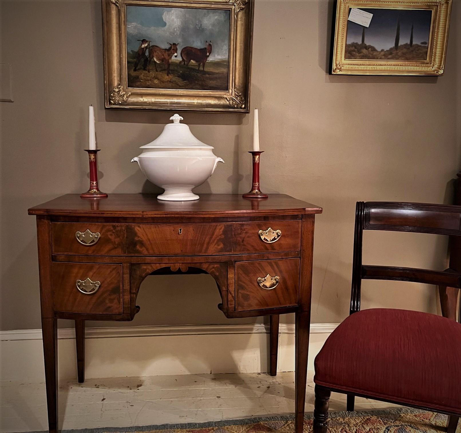 This beautiful petite sideboard/console has many uses: perfect as a console in the foyer or living room, equally great as a server in the breakfast room or dining room. The piece was bench made by a highly-skilled cabinet maker copying the Federal