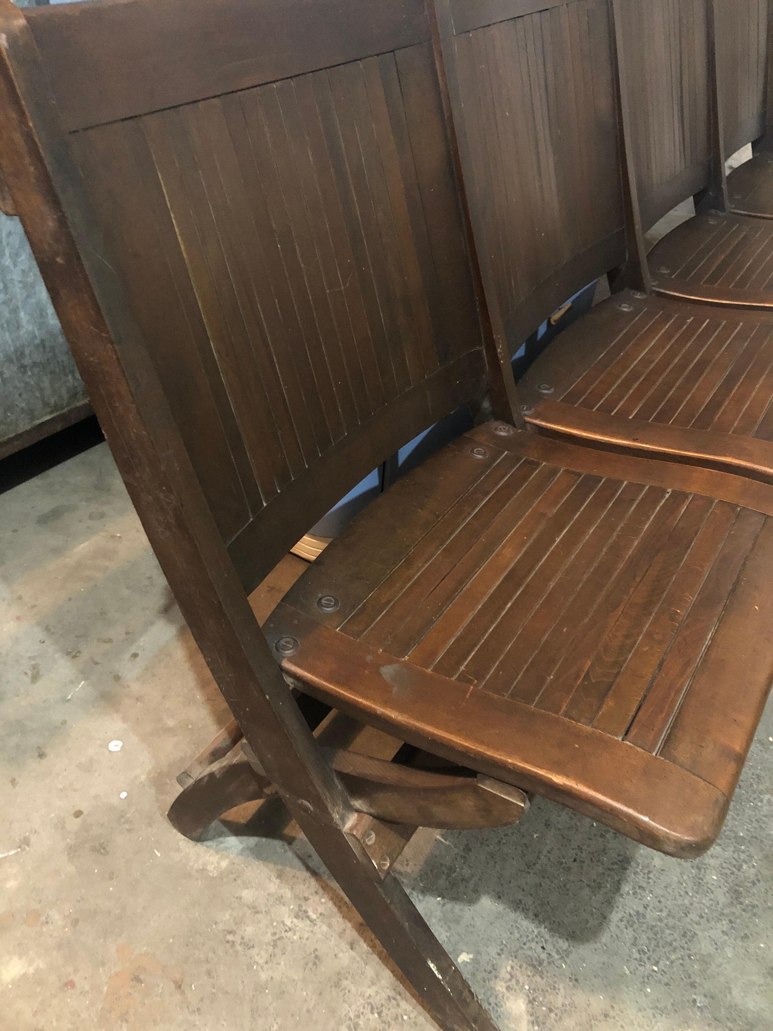 4-seat folding bench of oak, circa 1920s. Folds to small footprint for easy storage or transport. Classic early American simple-design-plus-function. Put it to use for extra seating in a narrow hallway. Use for holiday overflow seating. Make a