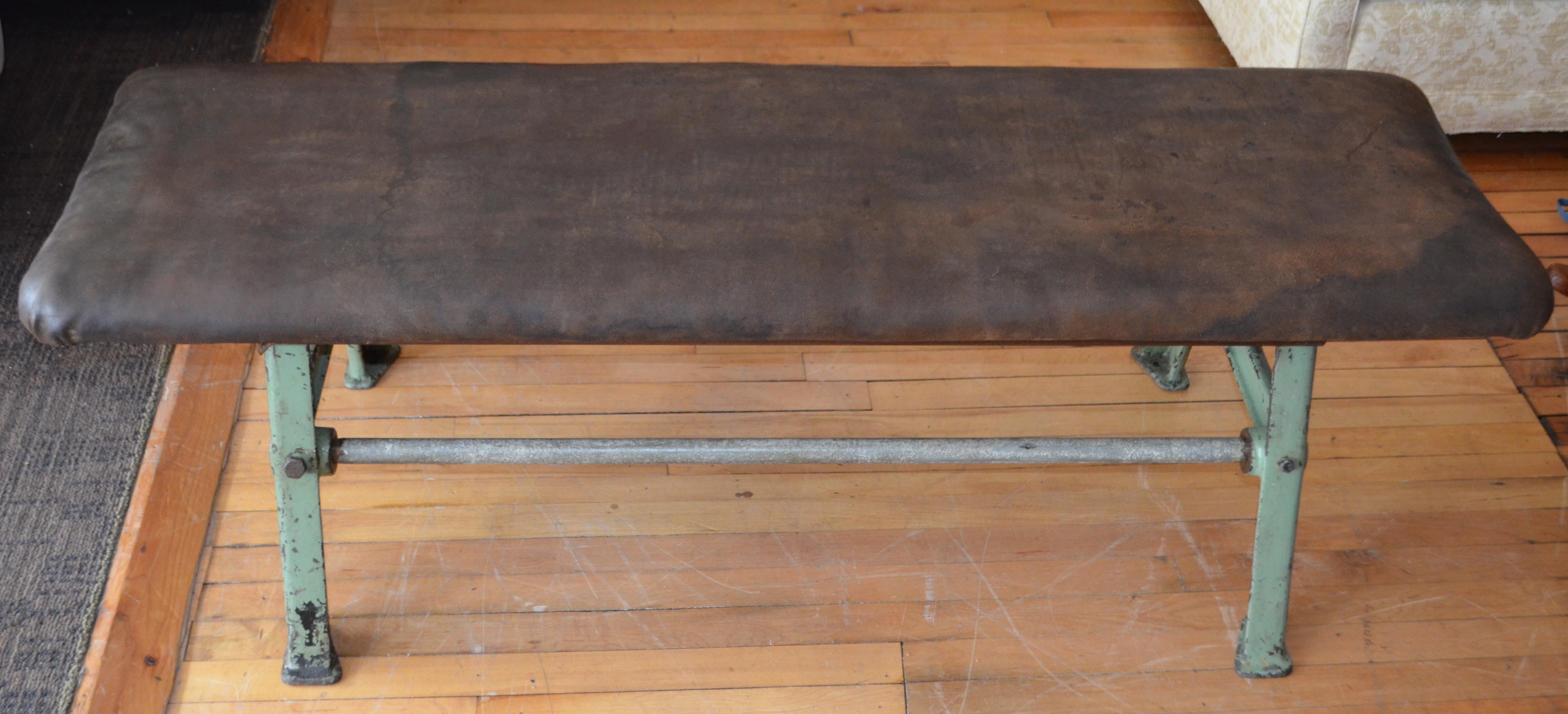 Early 20th century suede leather bench with rock solid, Industrial, forged iron base. Rock solid construction with highly-textured hand of leather. An early weight/barbell bench. Comfortable seating with the sense of strength and endurability