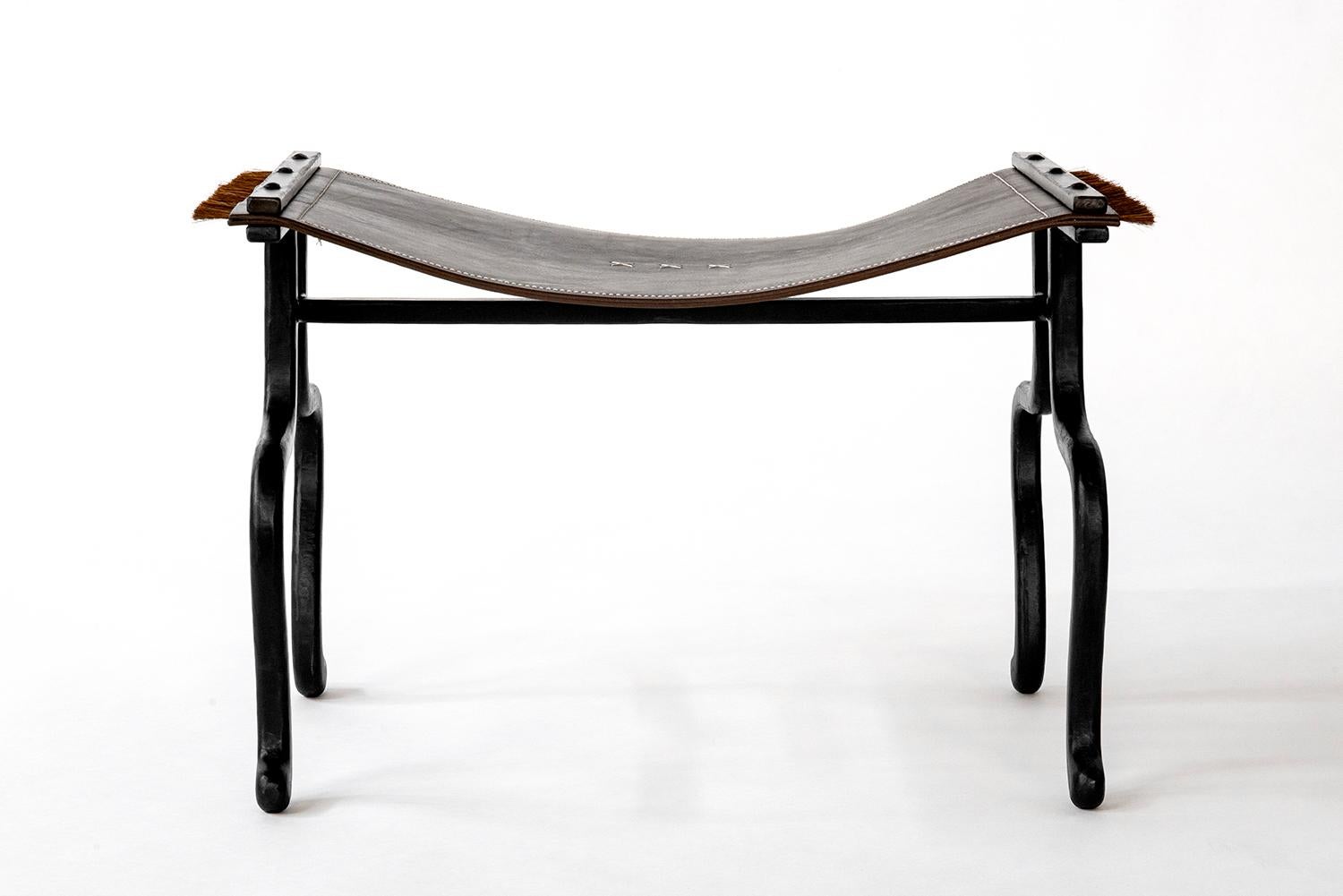 BENCH NO. 2
J.M. Szymanski
d. 2023

A carved iron frame is combined with soft saddle leather. The leather is intricately hand stitched with organic linen fused at the ends with a horsehair fringe. A modern classic for generations to come.  
 
Custom