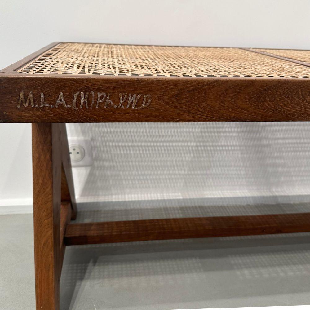  Bench in solid teak and woven cane. Rectangular seat resting
on two lateral 