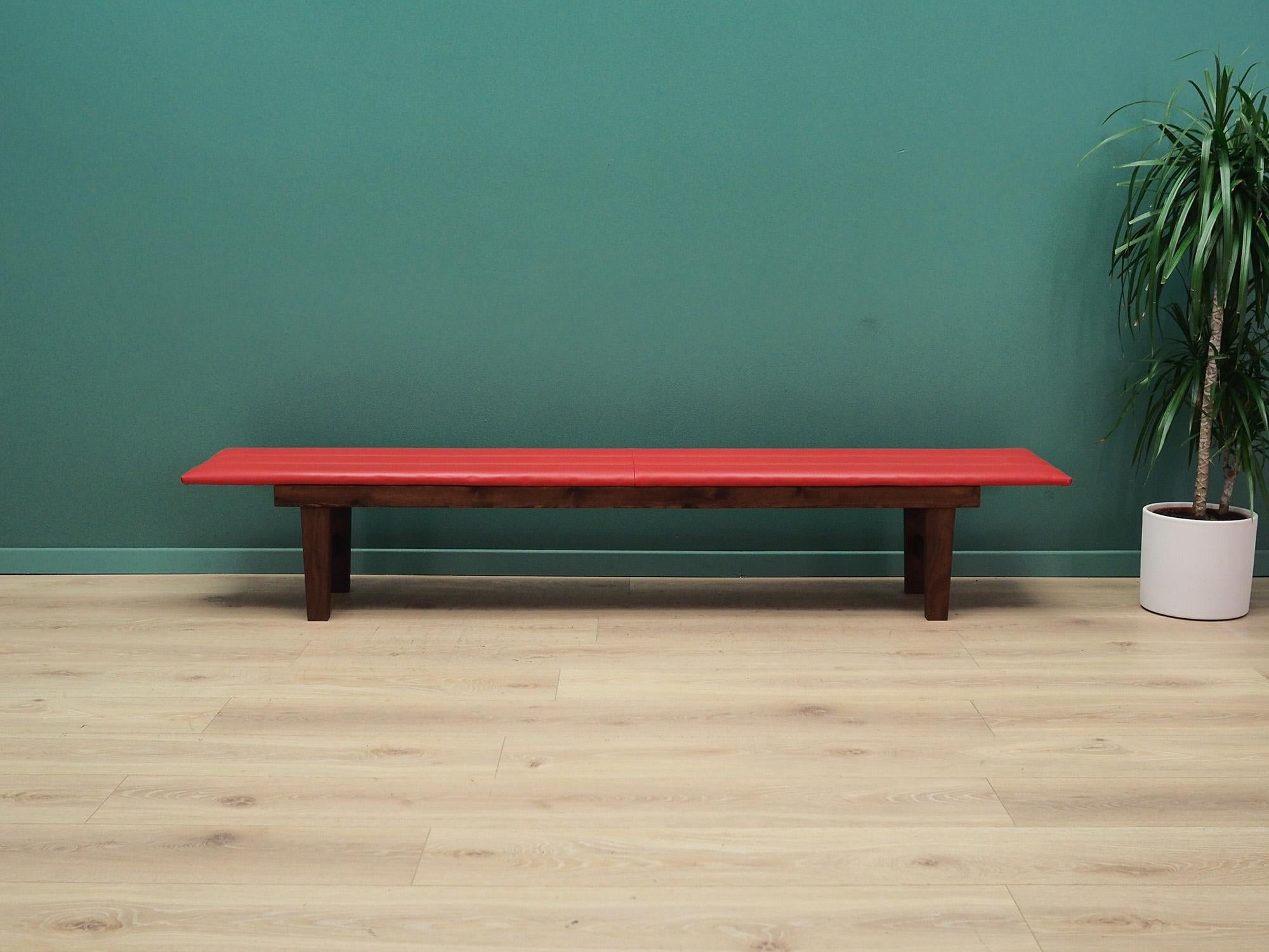 Bench made in the 1990s, Danish production.

The construction is made of teak wood. The seat is preserved in its original condition. Uupholstery is made of high quality eco leather in red. The ideal equipment for every waiting room in retro
