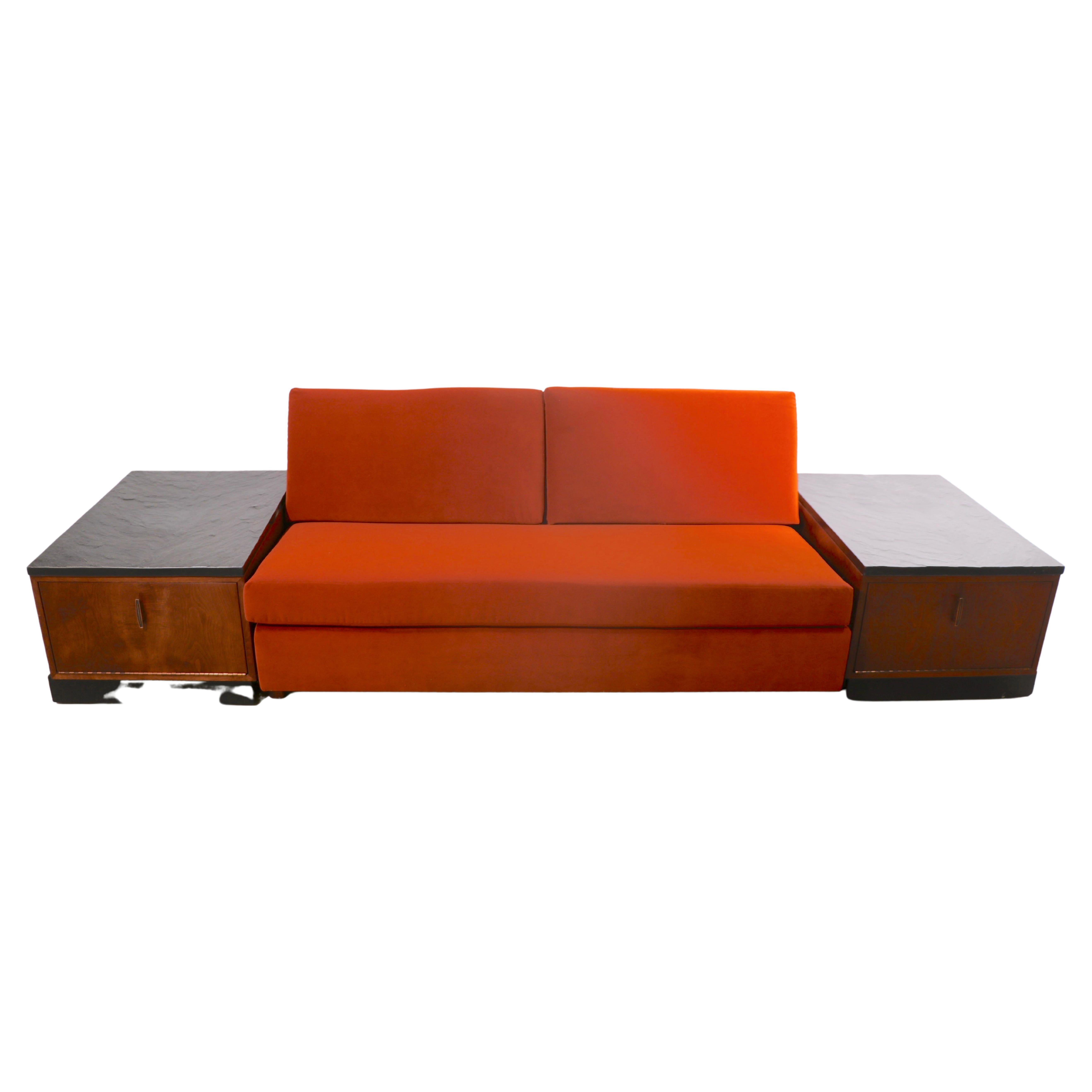 Architectural bench style sofa with cabinet end table sides, designed by Adrian Pearsall for Craft Associates. The sofa set consists of two end tables, each having a walnut case, with a pull down door front, with optional faux slate tops, on black