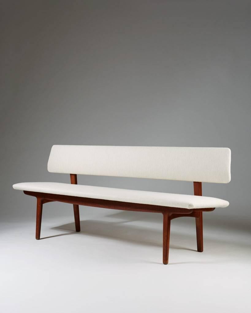 Bench with backrest designed by Ejnar Larsen & Axel Bender Madsen for Næstved Møbler, 
Denmark. 1957.

Solid teak and wool upholstery.
Measures:
H 74.5 cm/ 29 3/8