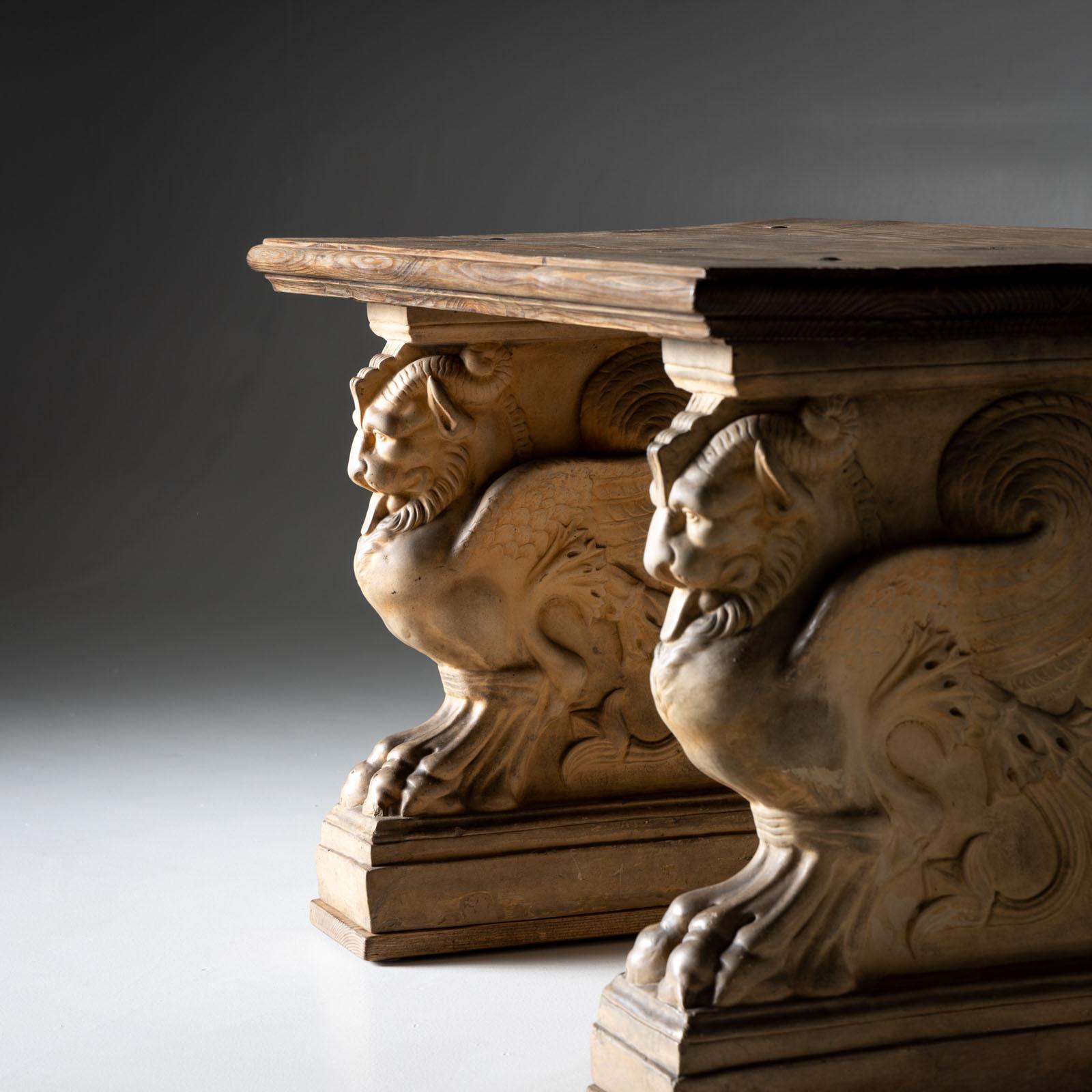 Bench with natural spruce seat and terracotta legs in the shape of winged chimeras. Stamped 