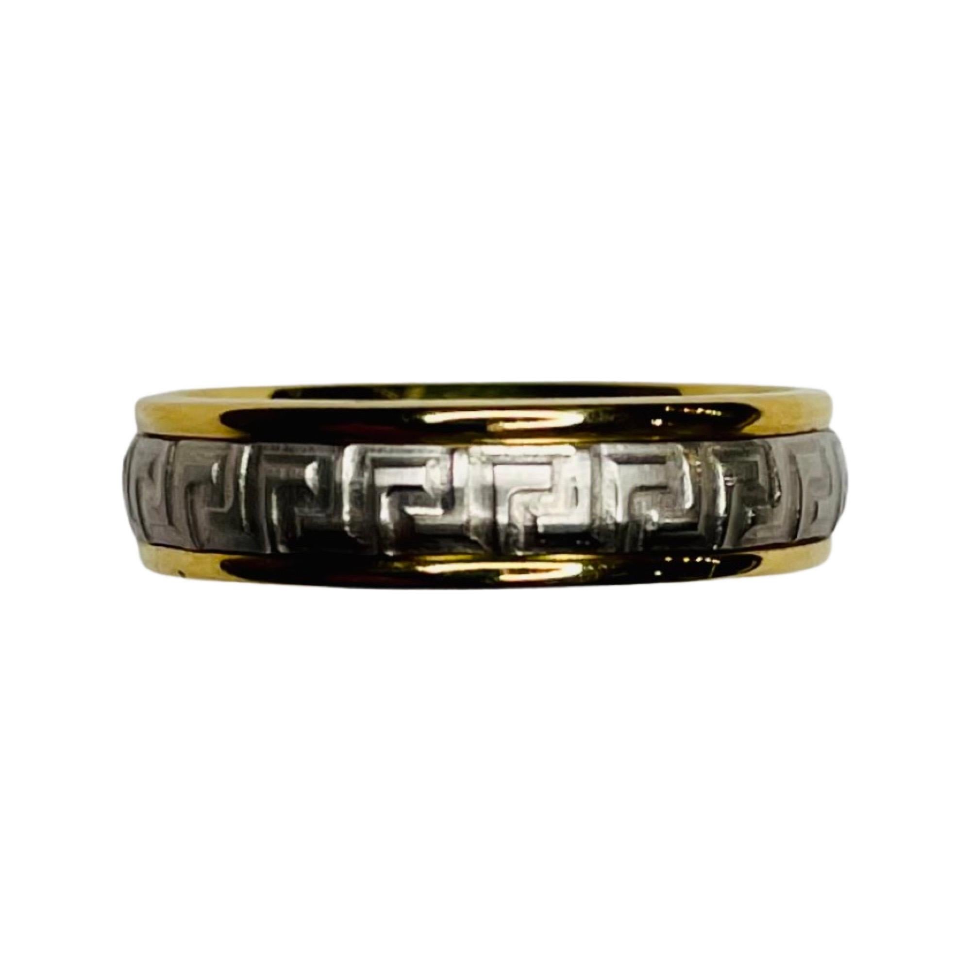Benchmark 18K Yellow Gold and Platinum Wedding Band. This is a comfort fit band. The band is 18KY Gold on the outside and Platinum on the inside.  The yellow gold has a high polish finish and the platinum has a matte finish. It has the Greek key