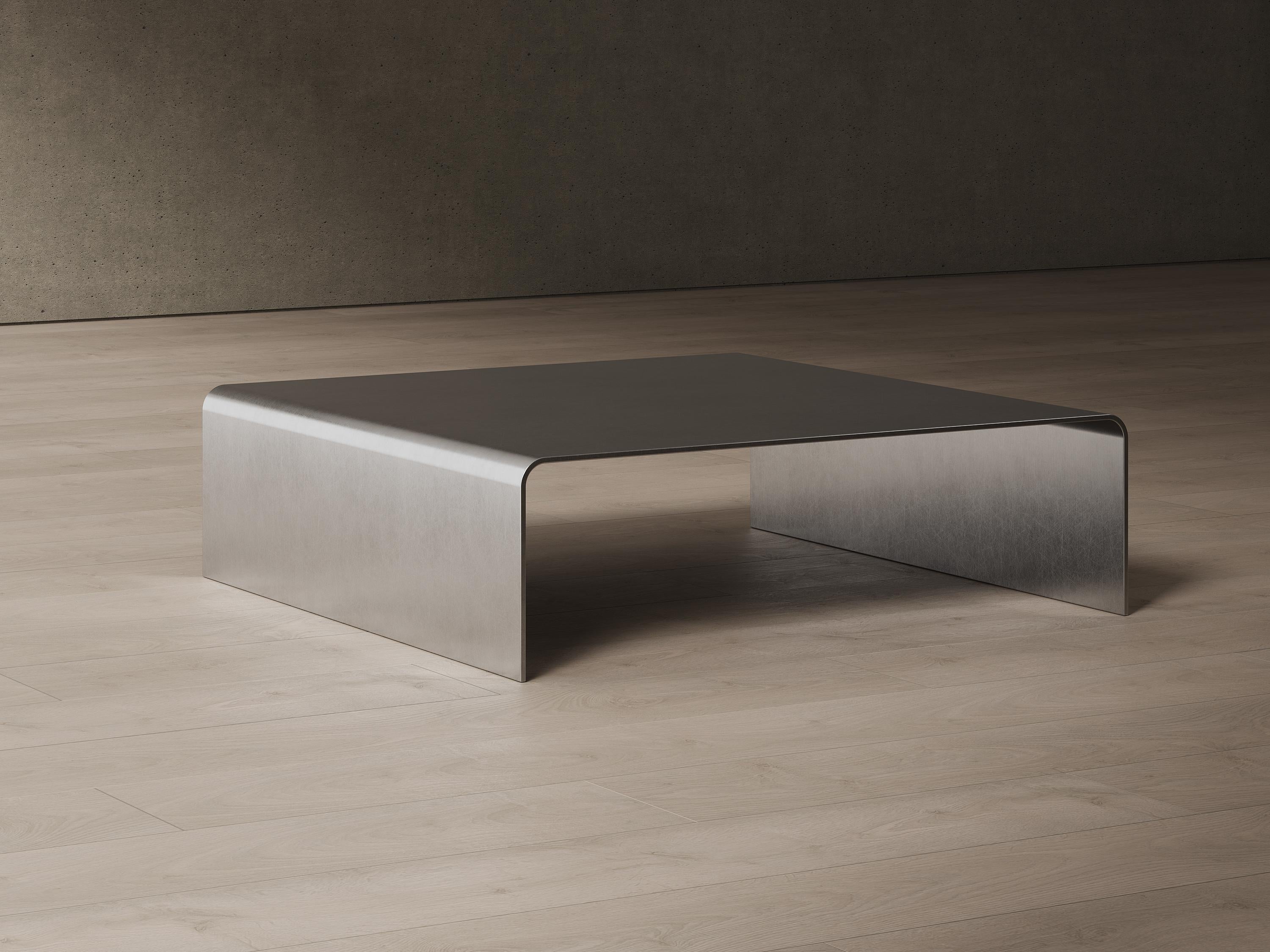 The Bend table portrays simplicity and elegance. It is made of a single sheet of 6mm stainless steel, creating a piece that has no screws or fixings. It comes in brushed stainless steel. Custom finishes are available upon request. Proudly made in