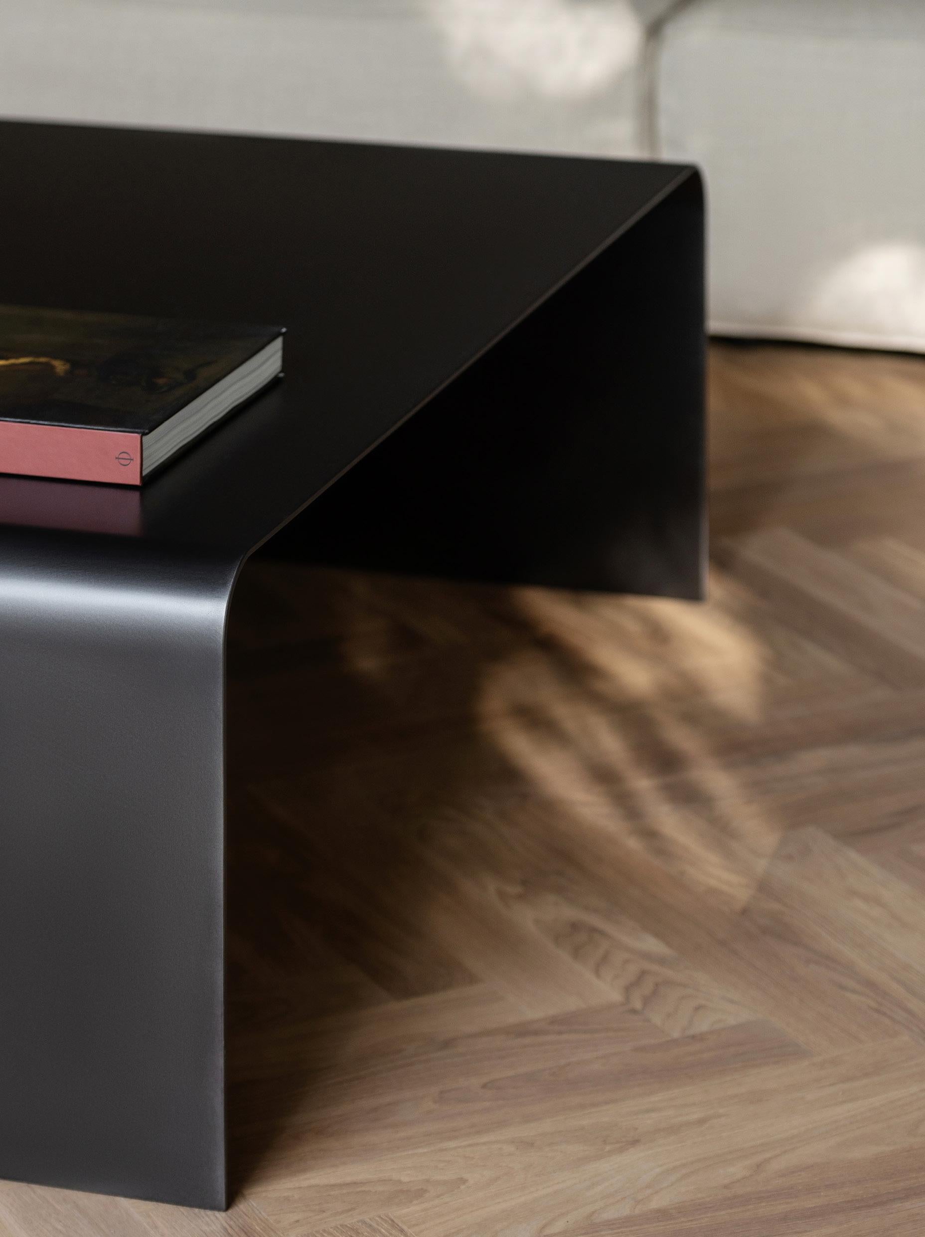 The Bend table portrays simplicity and elegance. It is made of a single sheet of 6mm stainless steel, creating a piece that has no screws or fixings. It comes in a burnt bronze finish. Custom finishes are available upon request. 