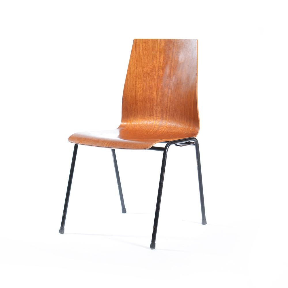 Really nice stacking chairs. Produced in Germany in 1960s. The seat made of bended teak plywood sits on a black metal construction. The chairs can be locked and joined together. Simple construction and very elegant finish. Very good condition with