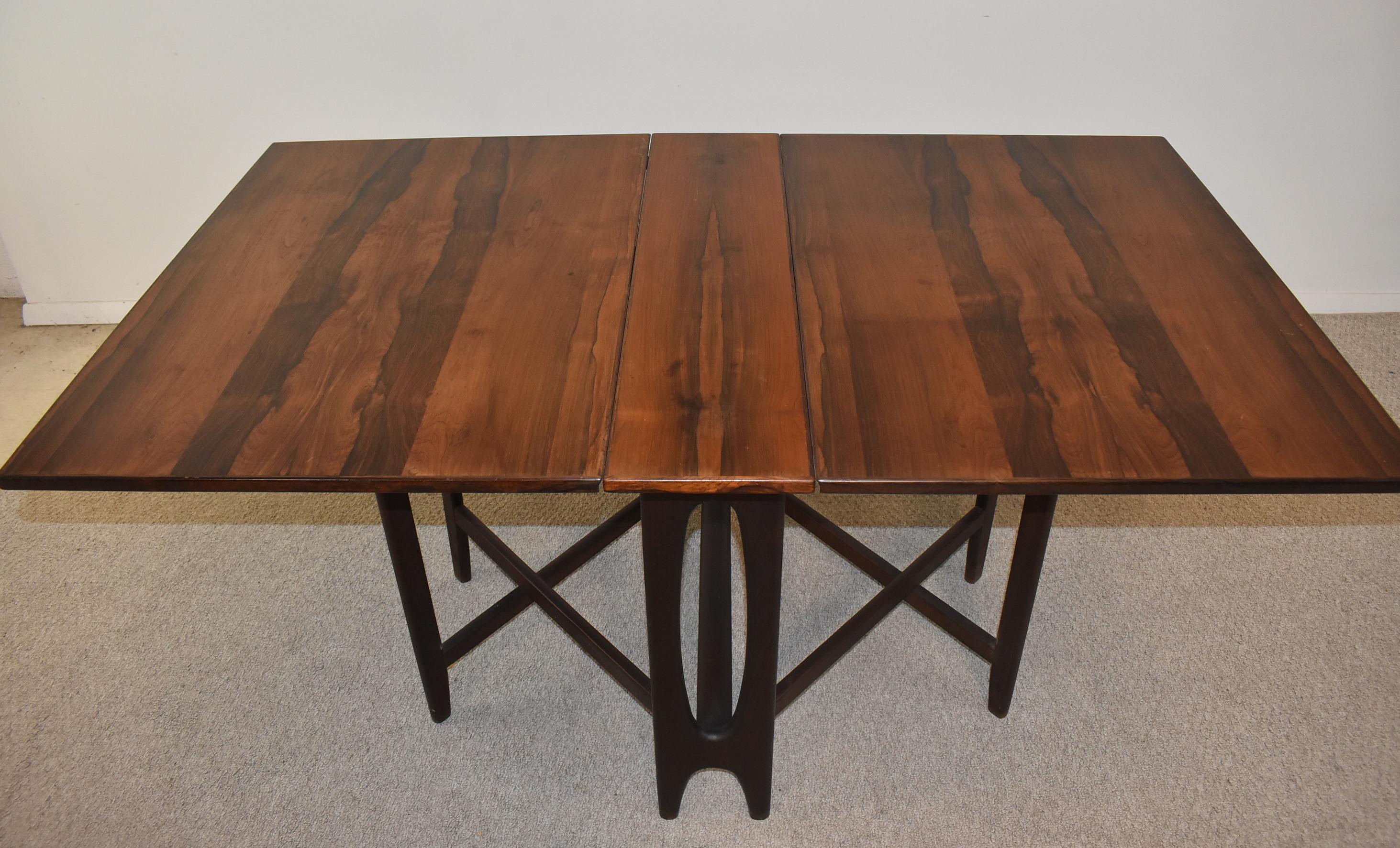 Classic Bendt Winge gate leg folding table in rosewood for Kleppes Mobelfabrik, Model No. 4. This versatile yet elegant table features a gate leg design around a center support with elliptical detail, which allows it to double as a console table