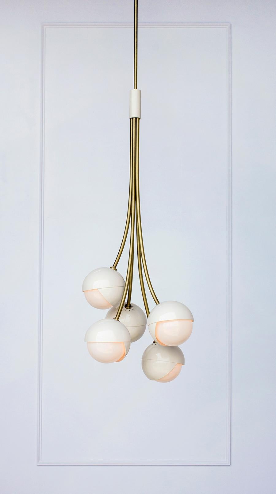 The Benedict™ Bloom chandelier suspends five pairs of nested brass hemispheres and white opal glass in an organic cluster held by hand rolled brass stems. Available in all Trella finishes the Benedict™ Bloom chandelier is able to make a playful yet