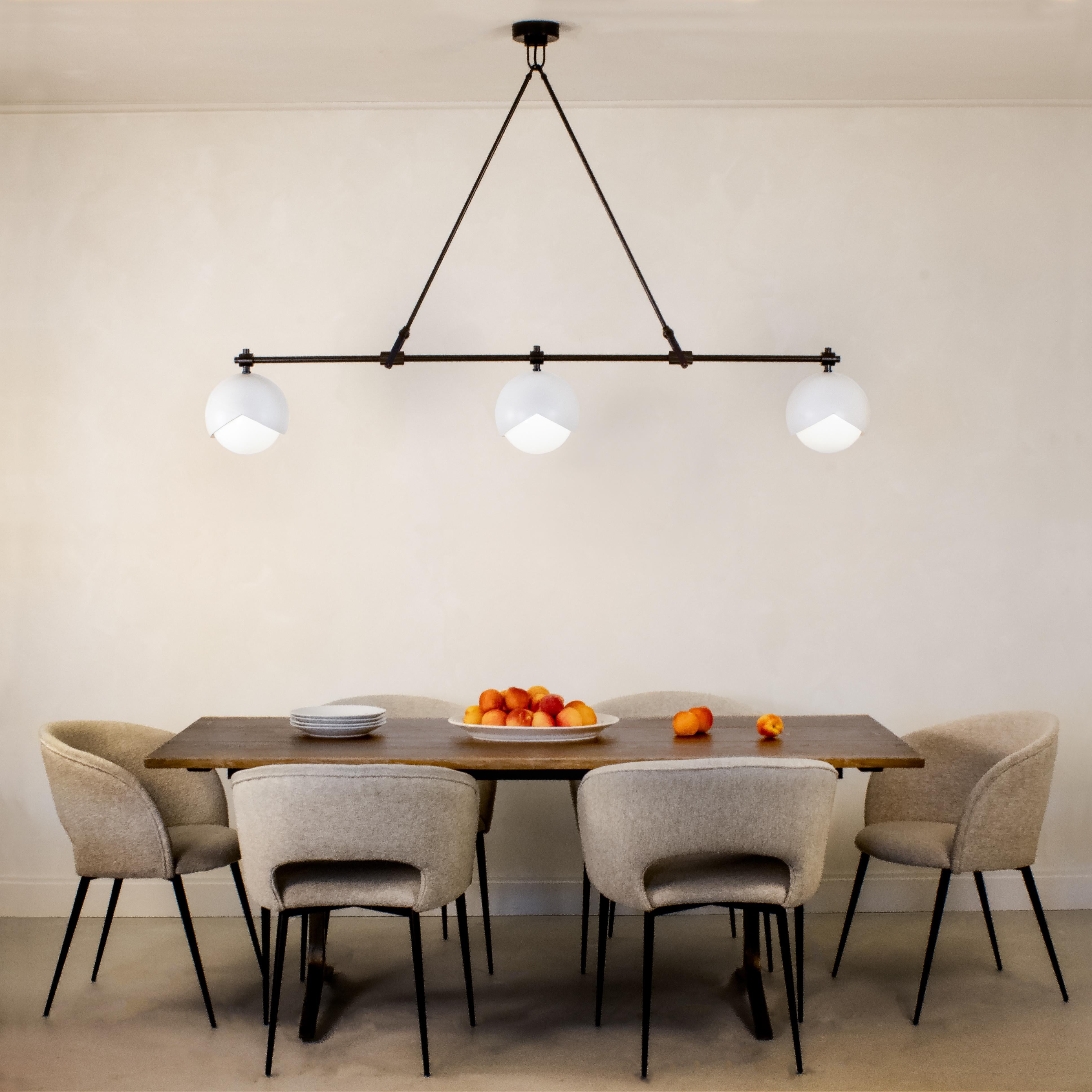 Three 9 inch Benedict™ light assemblies form a linear array held together with finely detailed joinery. Available in any height, this chandelier is an inviting centerpiece for any kitchen island, dining table, conference table, or artists’ studio