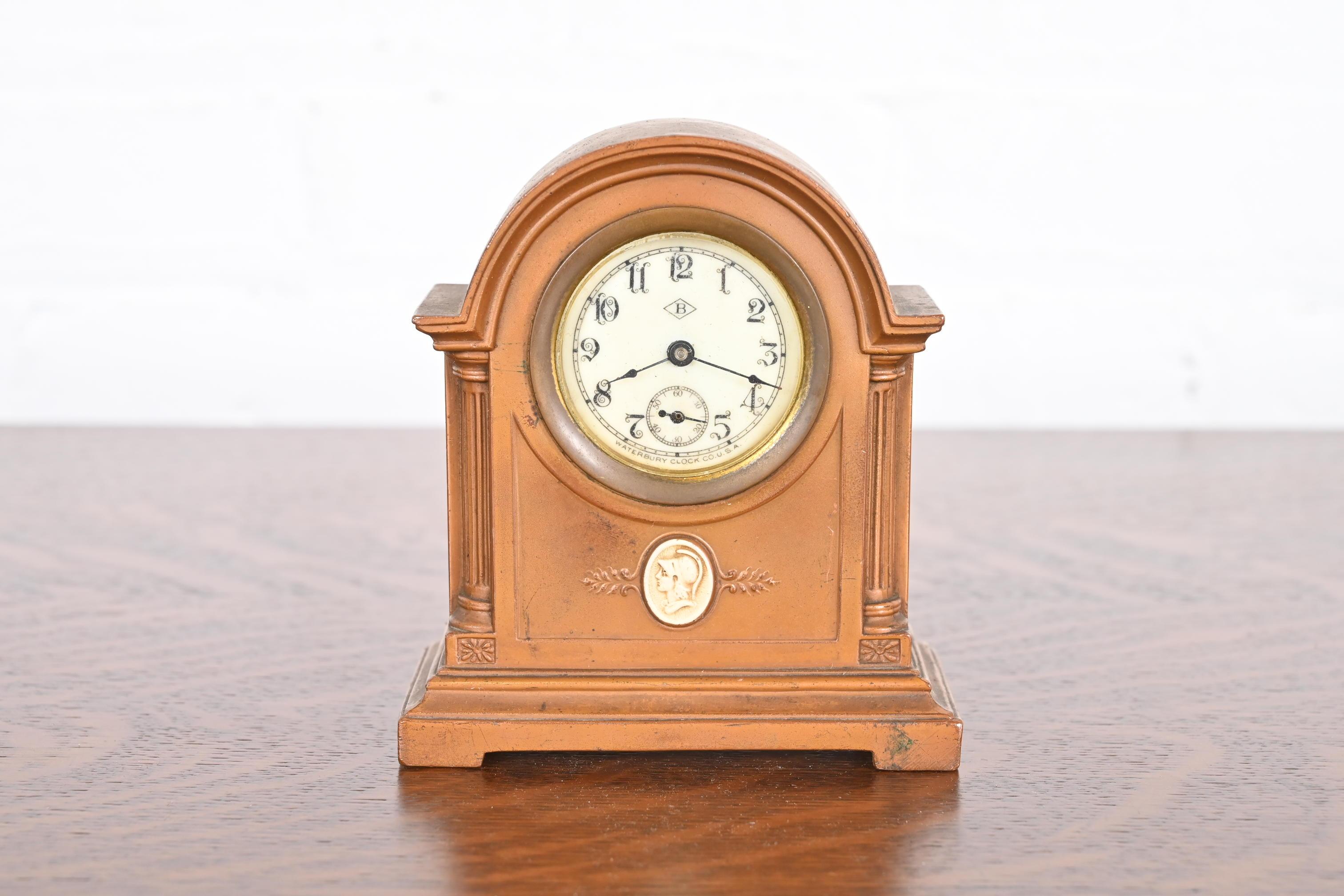 A gorgeous Arts & Crafts period bronze mantel clock with an emblem of a classical Greek figure.

By Benedict Studios (signed to the underside)

USA, Circa 1910

Measures: 4.38