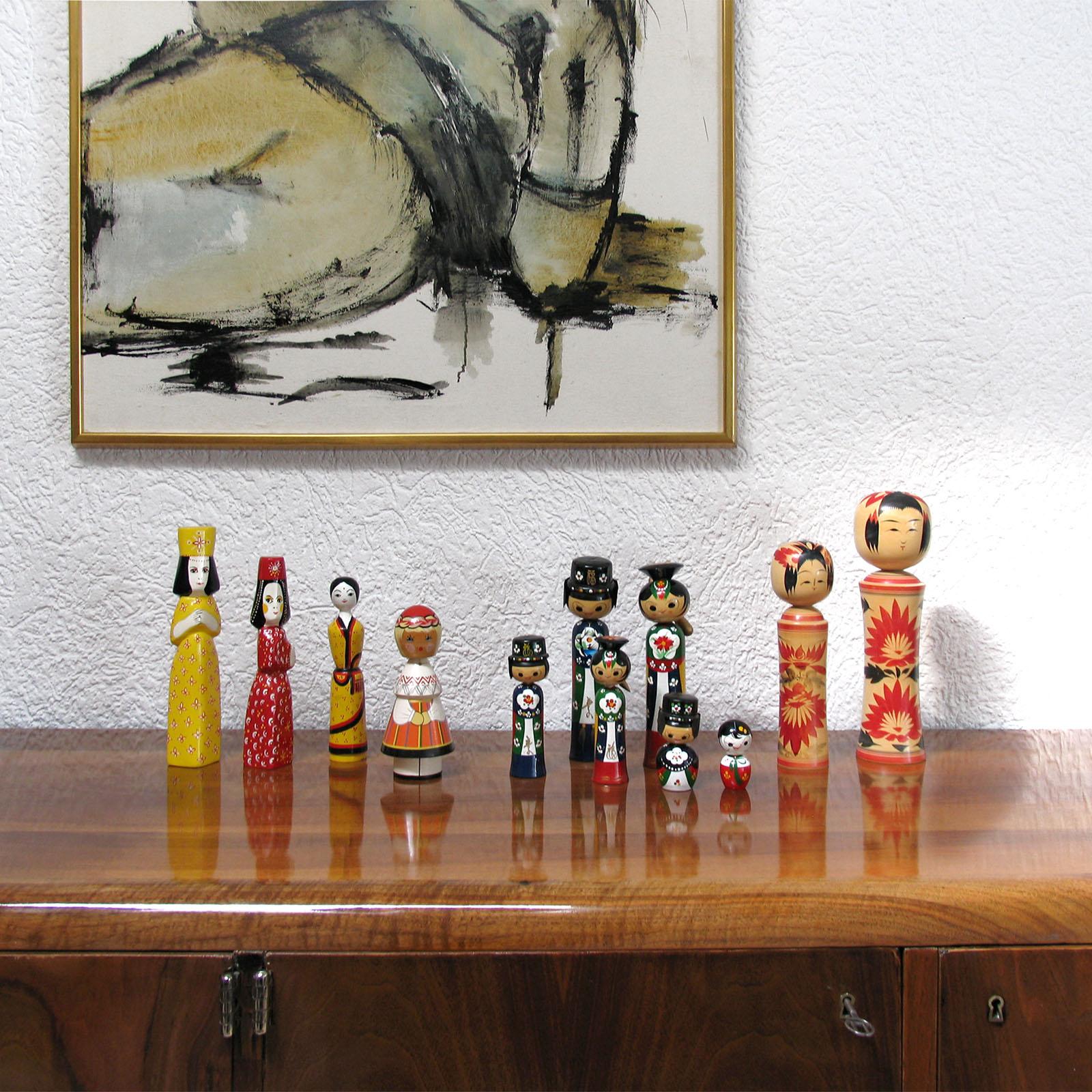 Three hand-carved wooden dolls, hand painted in vivid colors.
The two on the left side were made by the Swedish artist Benedicte Bergmann. Part of the hand carved wooden dolls 