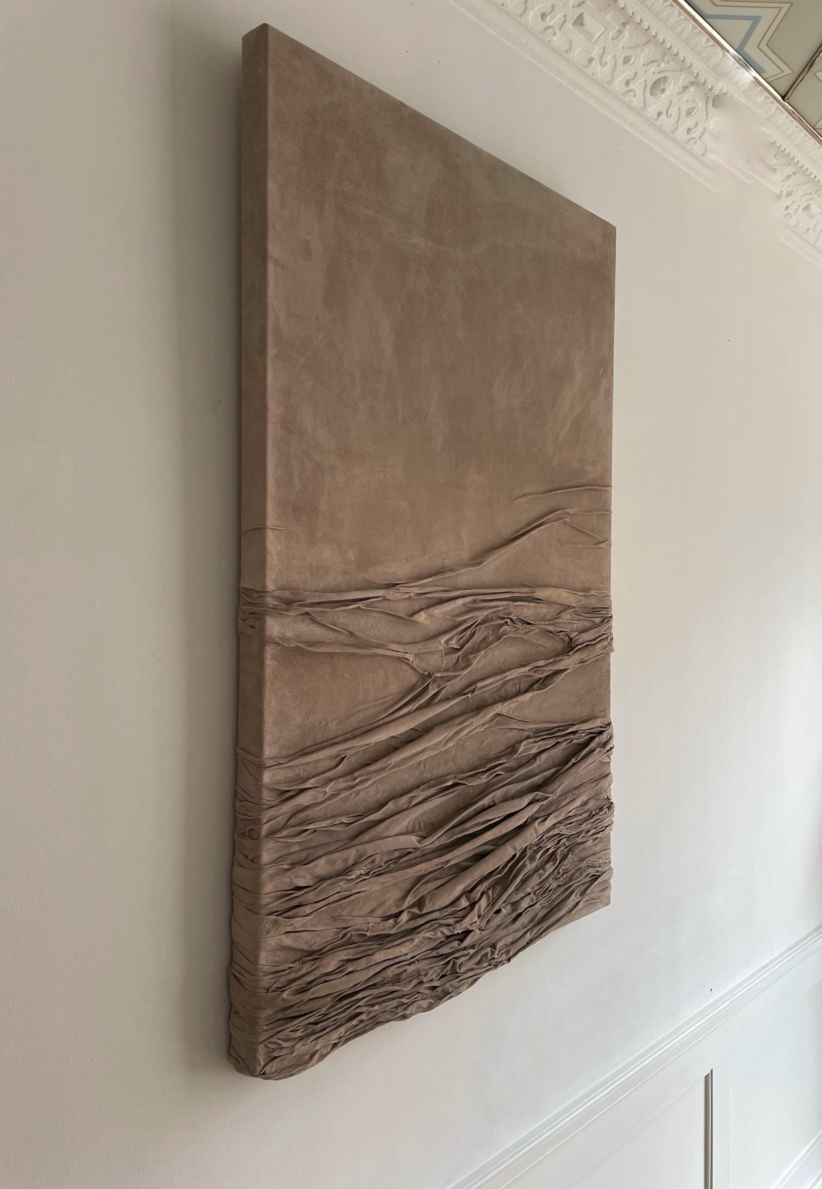 This elegant and contemporary relief artwork is crafted by Danish artist Benedicte Maria Bech Pedersen (1988-), known for her unique approach to leather as a medium. The large feminine relief is made of a one-piece suede leather, which is