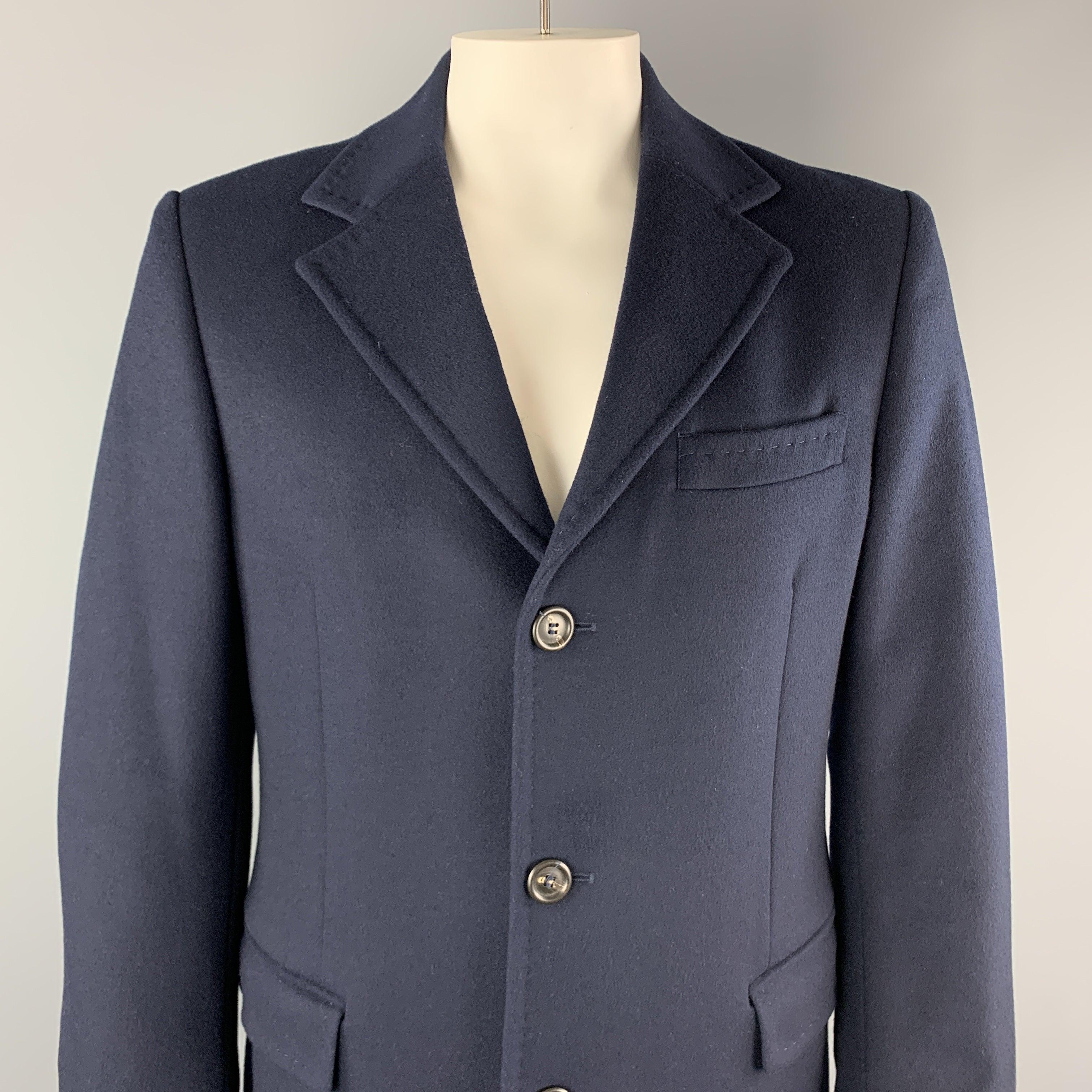 UNITED COLORS OF BENETTON coat comes in navy wool blend with a top stitch notch lapel, single breasted, three button front, and flap pockets.
Very Good
Pre-Owned Condition. 

Marked:  IT 52 

Measurements: 
 
Shoulder: 19 inches Chest:
46 inches
