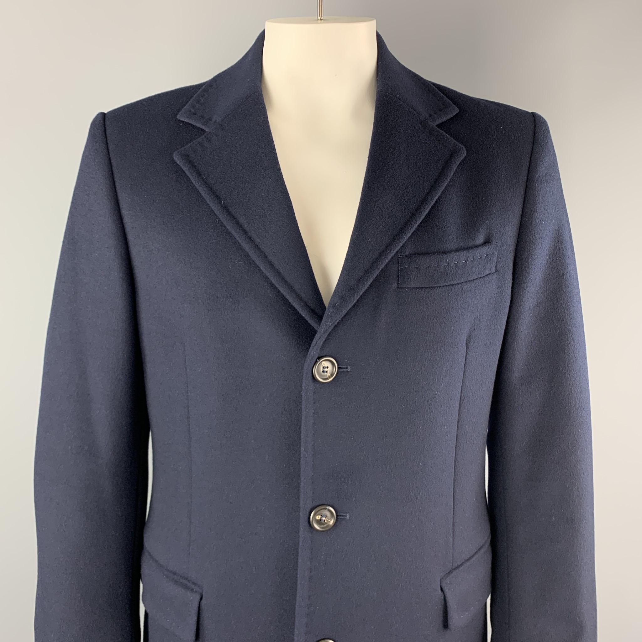 UNITED COLORS OF BENETTON coat comes in navy wool blend with a top stitch notch lapel, single breasted, three button front, and flap pockets. 

Very Good Pre-Owned Condition.
Marked: IT 52

Measurements:

Shoulder: 19 in.
Chest: 46 in.
Sleeve: 26