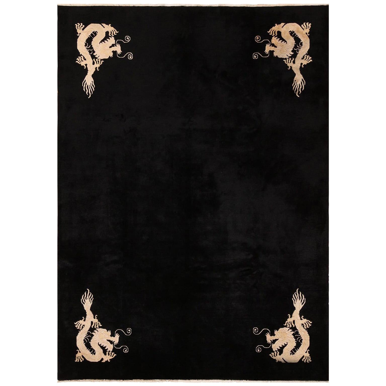 Magnificent room size benevolent five clawed dragon design black antique Chinese rug, country of origin / rug type: China rug, date circa 1920. Size: 7 ft x 9 ft 6 in (2.13 m x 2.9 m).

The benevolent Chinese dragon design is a protective symbol