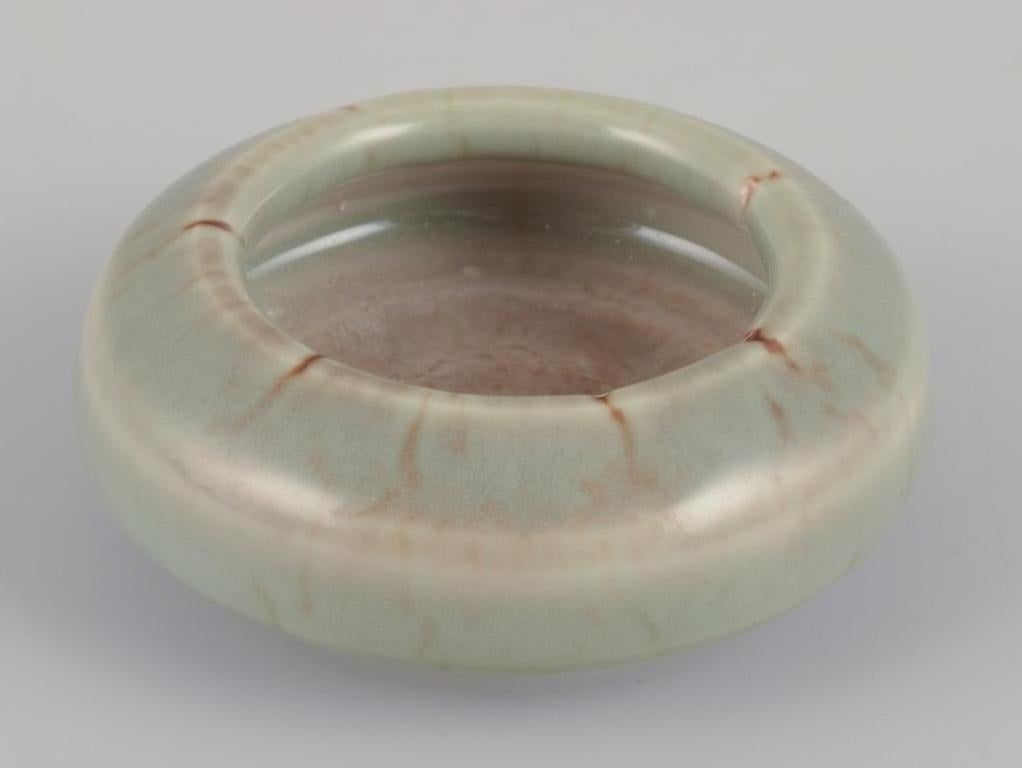 Bengt Ekeblad (1922-2003), Swedish ceramist for Rörstrand.
Unique miniature ceramic bowl with glaze in greenish shades. 
A rare piece.
Marked and dated '64 (1964).
In perfect condition.
First factory quality.
Dimensions: Diameter 8.0 cm x Height 3.0
