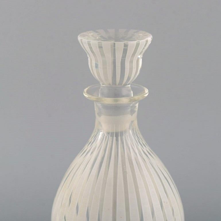 Bengt Orup for Johansfors. Strikt carafe in mouth-blown art glass. 1950s / 60s.
Measures: 24 x 9.5 cm.
In excellent condition.