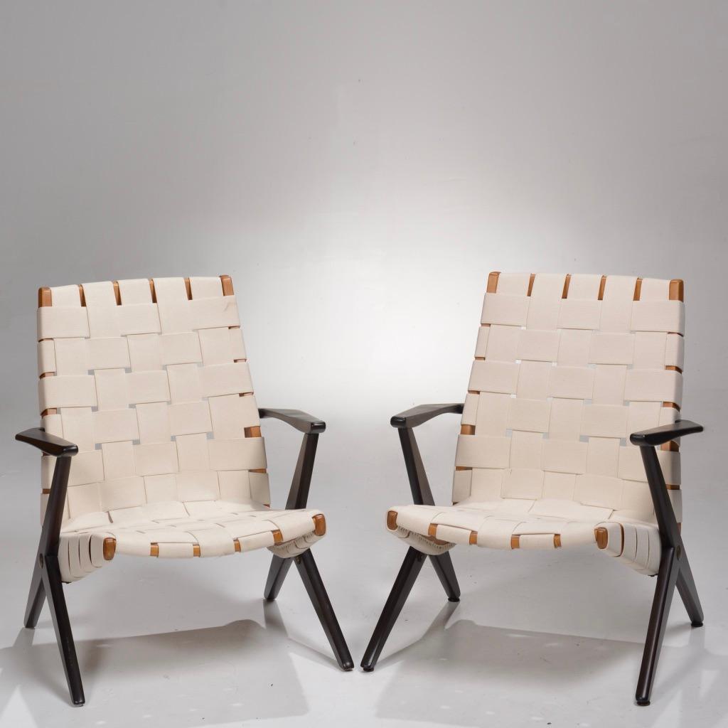 Pair of rare easy chairs designed by Bengt Ruda for Nordiska Kompaniet of Sweden. Circa 1950s
lounge armchairs featuring canvas straps, brass details, and a wooden frame. Both chairs are fully restored and retain thier makers mark plaque. Priced
