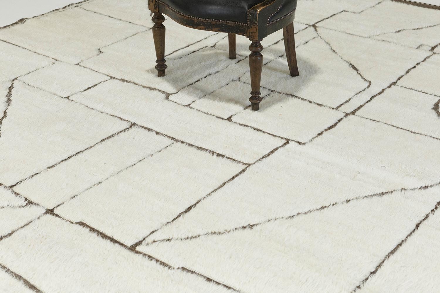 'Benhaddou' is a beautiful textured rug with embossed detailing into an overall geometric and contemporary design. Line work moving irregularly brings movement and are inspired by the Atlas Mountains in Morocco for the modern design world. The rug's