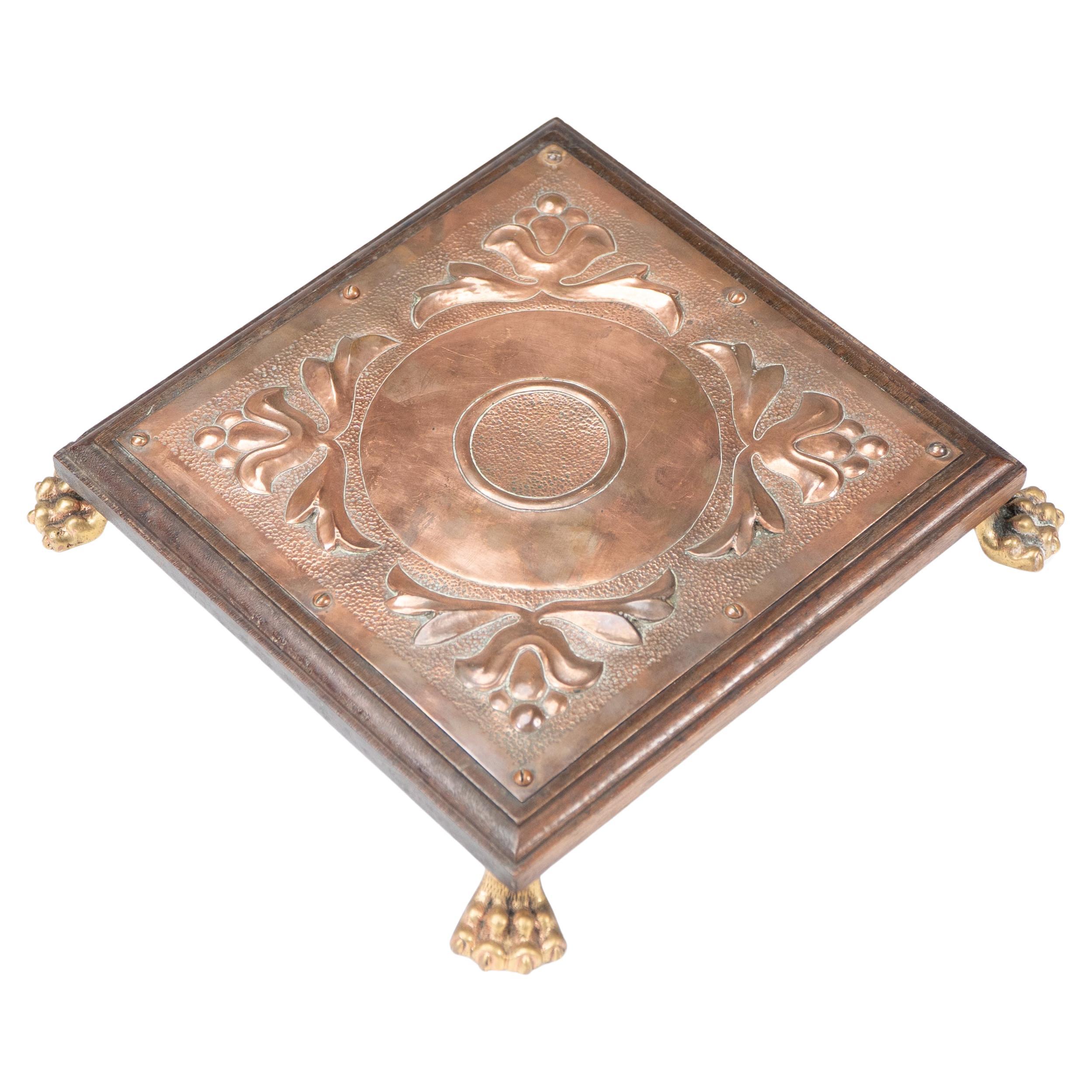 Benham & Froud attri. An Arts & Crafts copper and oak teapot stand or trivet