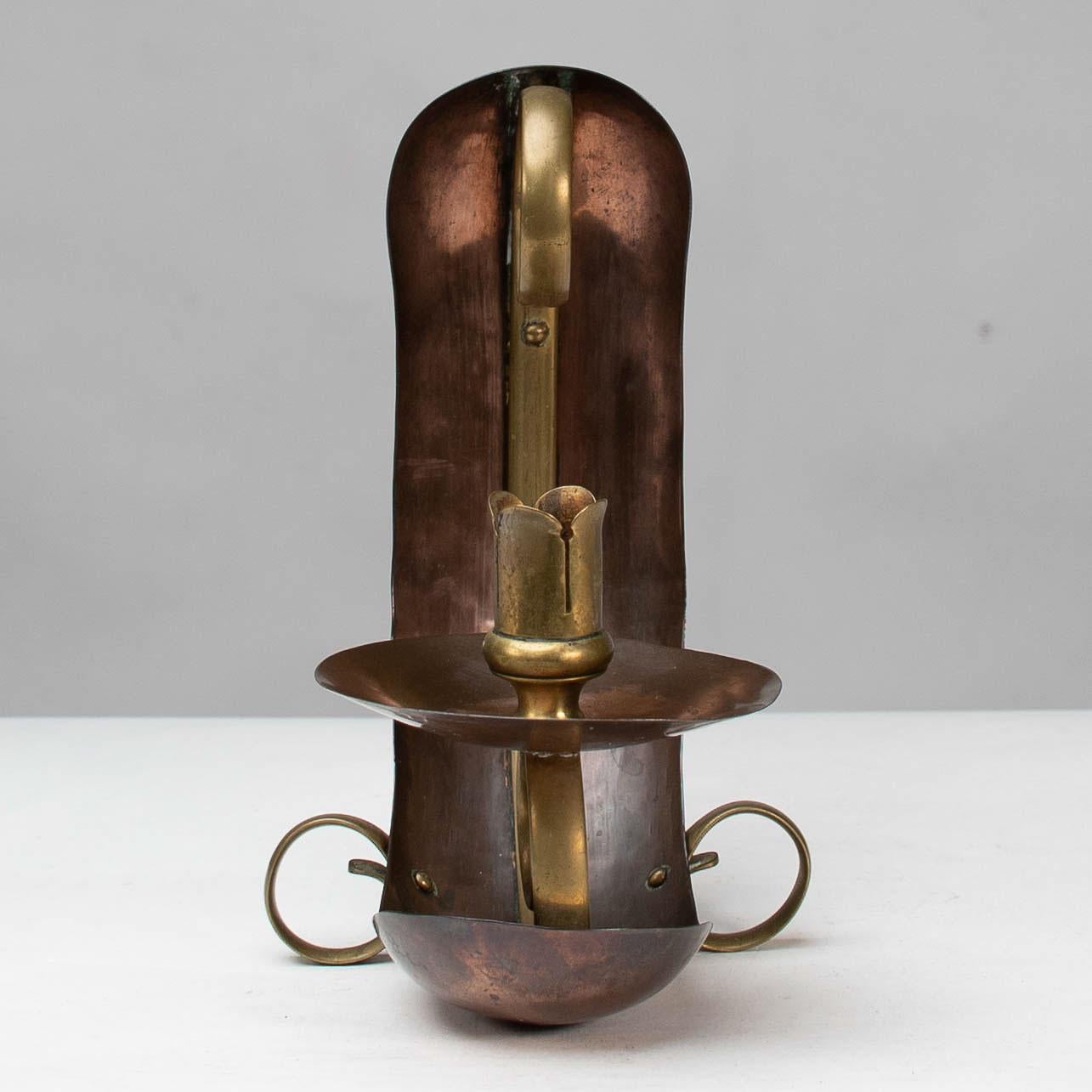 Benham & Froud. Attributed. An English Arts & Crafts copper & brass night light or candle holder. The main body is made from copper which helps magnify the flame giving a little more light. The scrollwork handle has a sweet little leaf detail to the