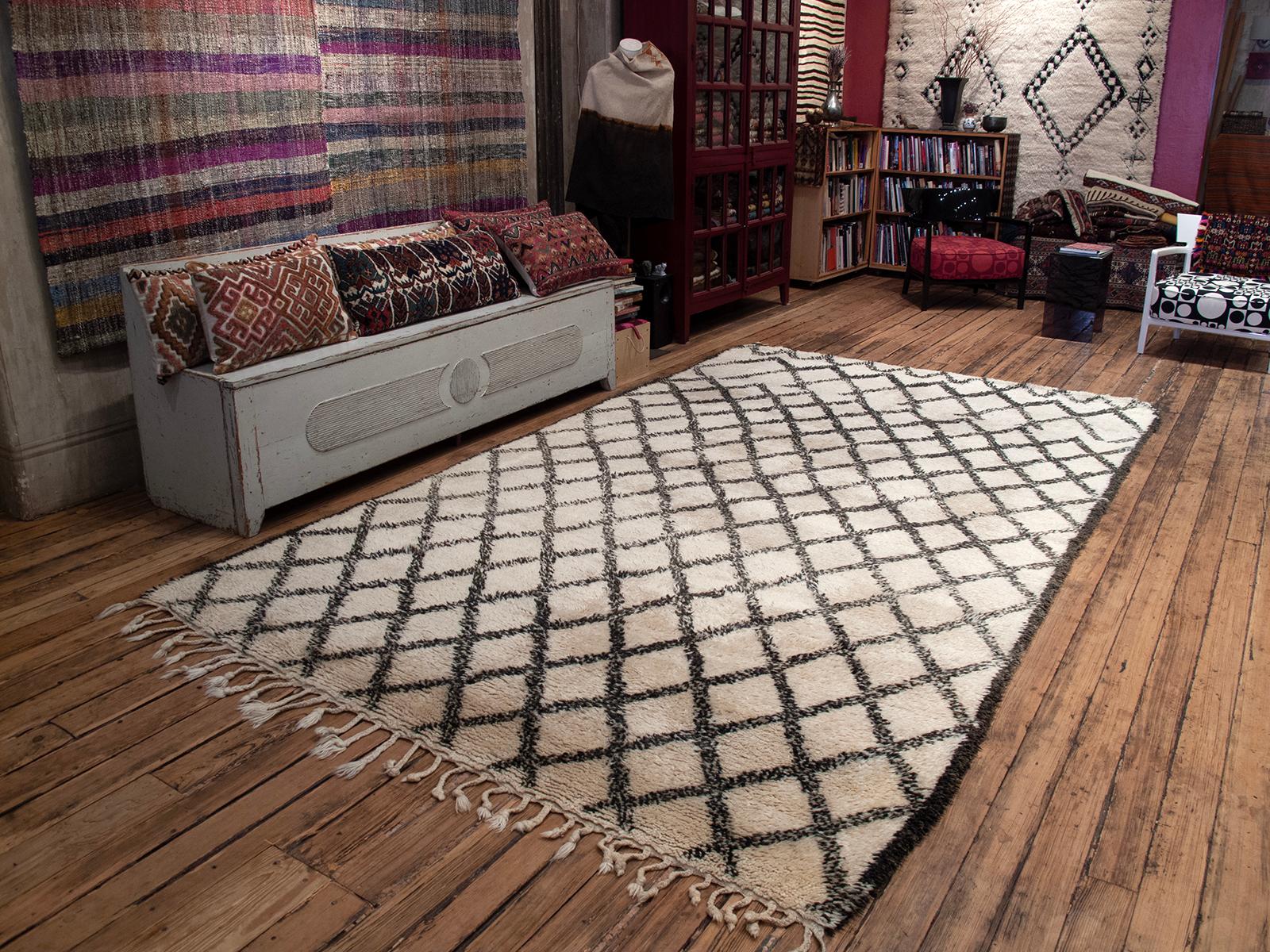 A classic Beni Ouarain tribal carpet from the Northeastern Middle Atlas Mountains, with the typical diamond grid pattern in small scale - note the pattern change at the bottom, which is where the weaver started, showing a bit of a struggle to decide
