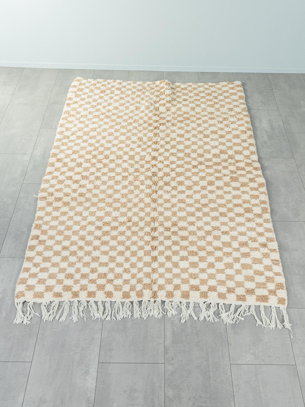 Tiny Sand Check is a contemporary 100% wool rug – thick and soft, comfortable underfoot. Our Berber rugs are handwoven and handknotted by Amazigh women in the Atlas Mountains. These communities have been crafting rugs for thousands of years. One