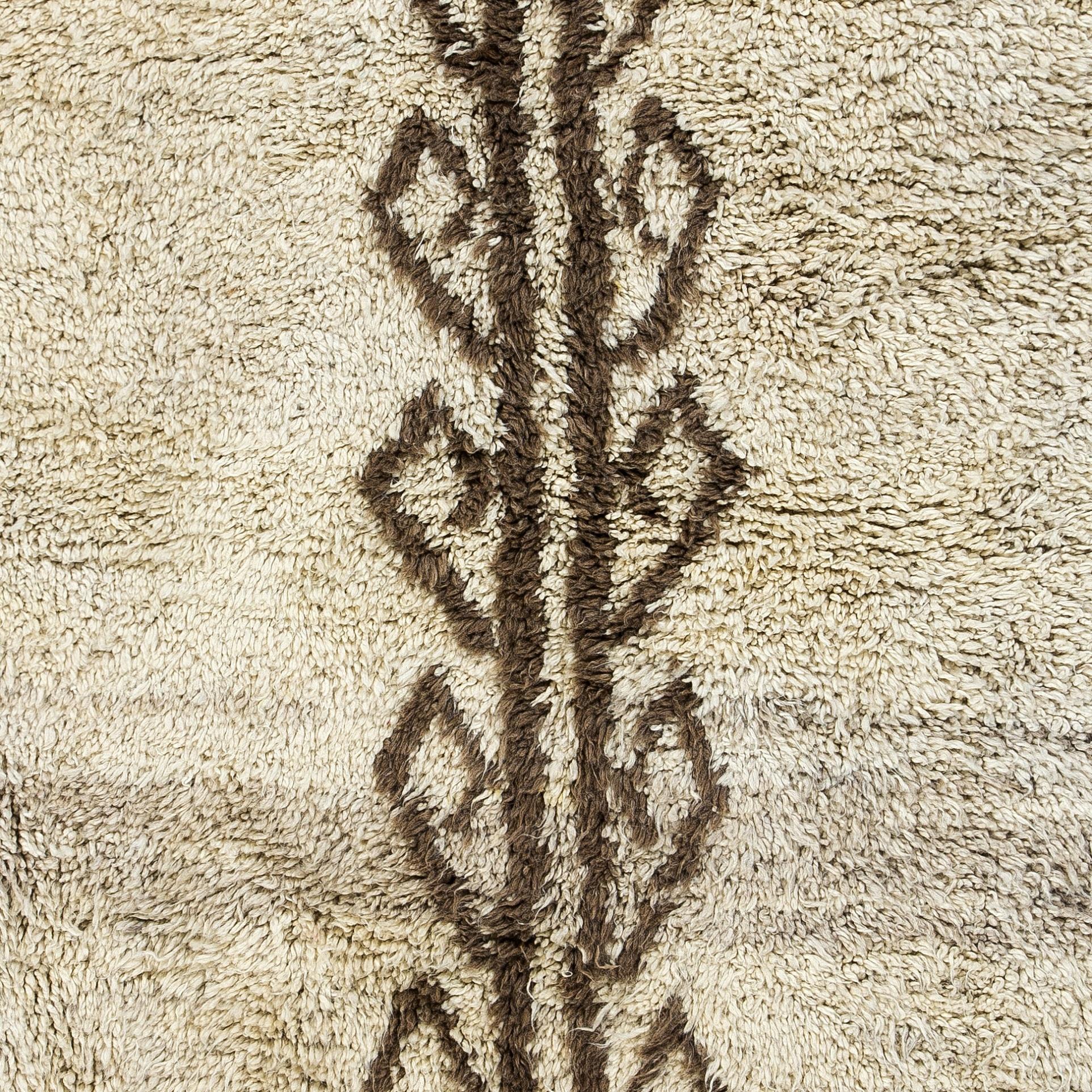Transform your space with the understated luxury of our Moroccan-style hand-knotted Tulu rug, inspired by the heritage-rich designs of the Beni Ourain tribes. This rug is a celebration of craftsmanship and tradition, entirely handmade by skilled