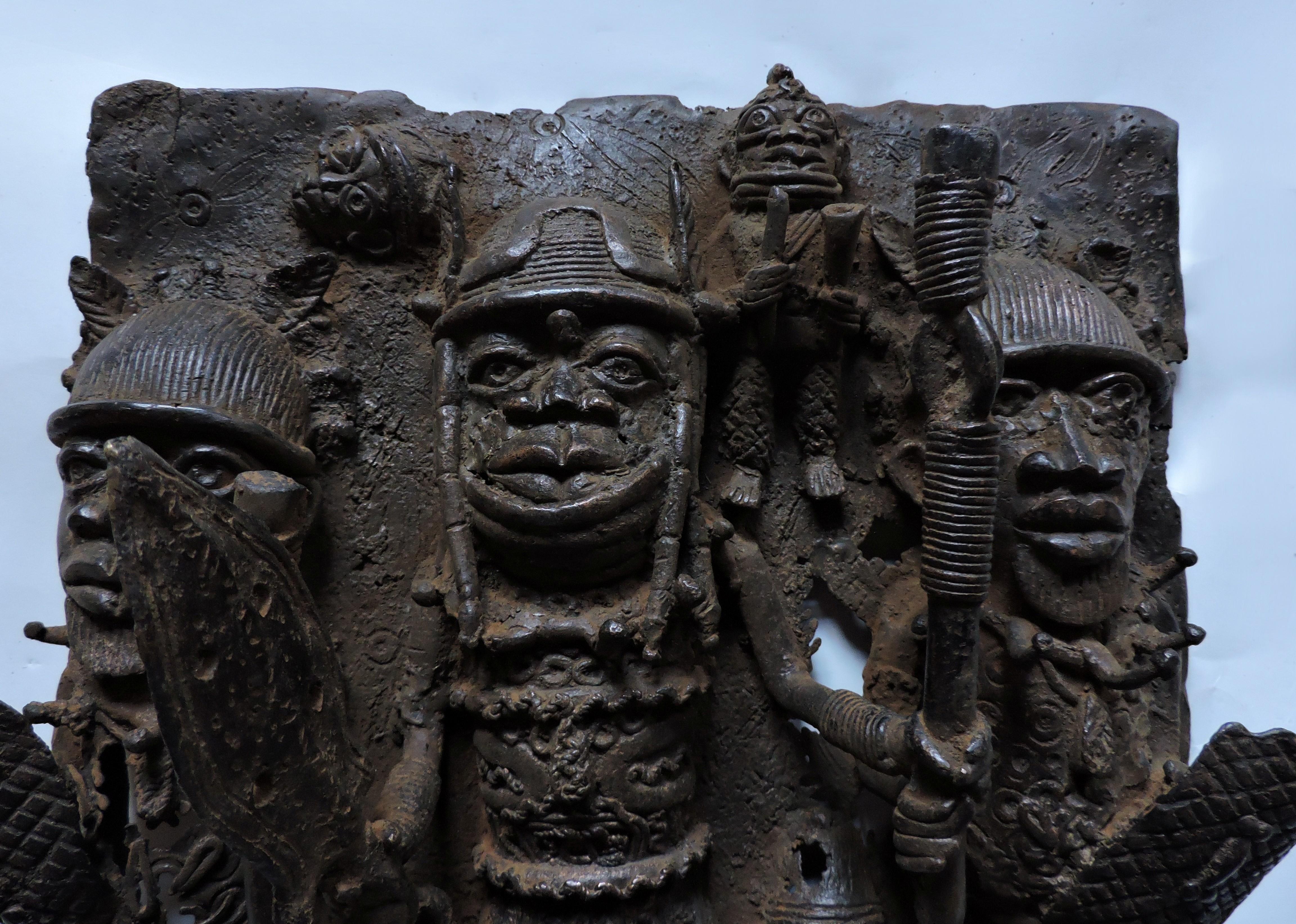 Striking and detailed bronze relief sculpture from Benin, now known as Nigeria, in Africa. This piece was modeled after ancient Benin bronzes, but is from the 20th Century. The intricate imagery was sculpted in high relief by hand and then cast in