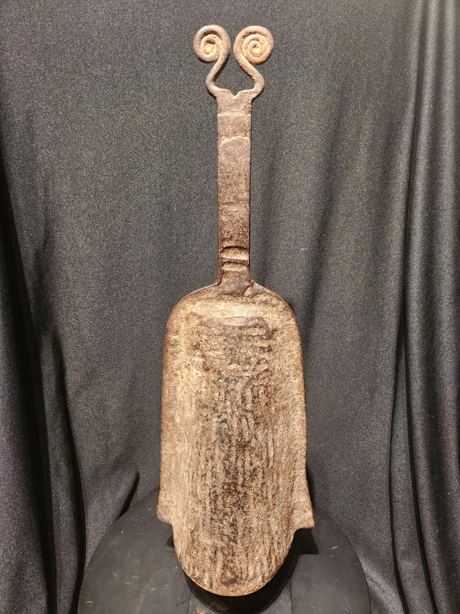An elegant Benin Iron Striker Bell with a double spiral finial on the top, and a lovely bell-shaped body. This is an extremely fine example of the African blacksmiths artistry. Kingdom of Benin, West Africa, Ca, late 19th/early 20th Century.