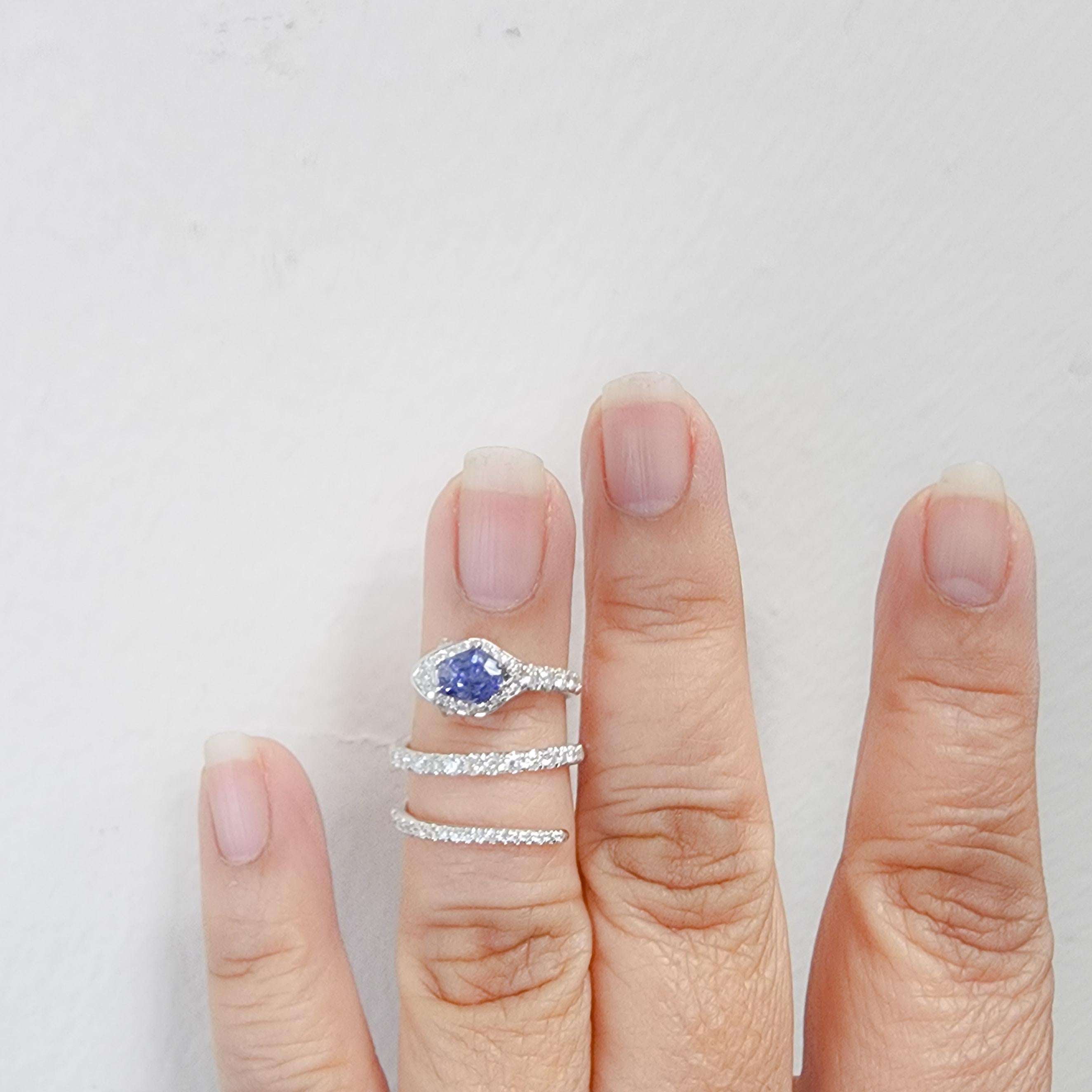 Beautiful 0.87 ct. benitoite in a fancy shape with good quality white diamond rounds.  Snake design.  Ring size 6.75.  Handmade in 18k white gold. This stone is native to Callifornia.