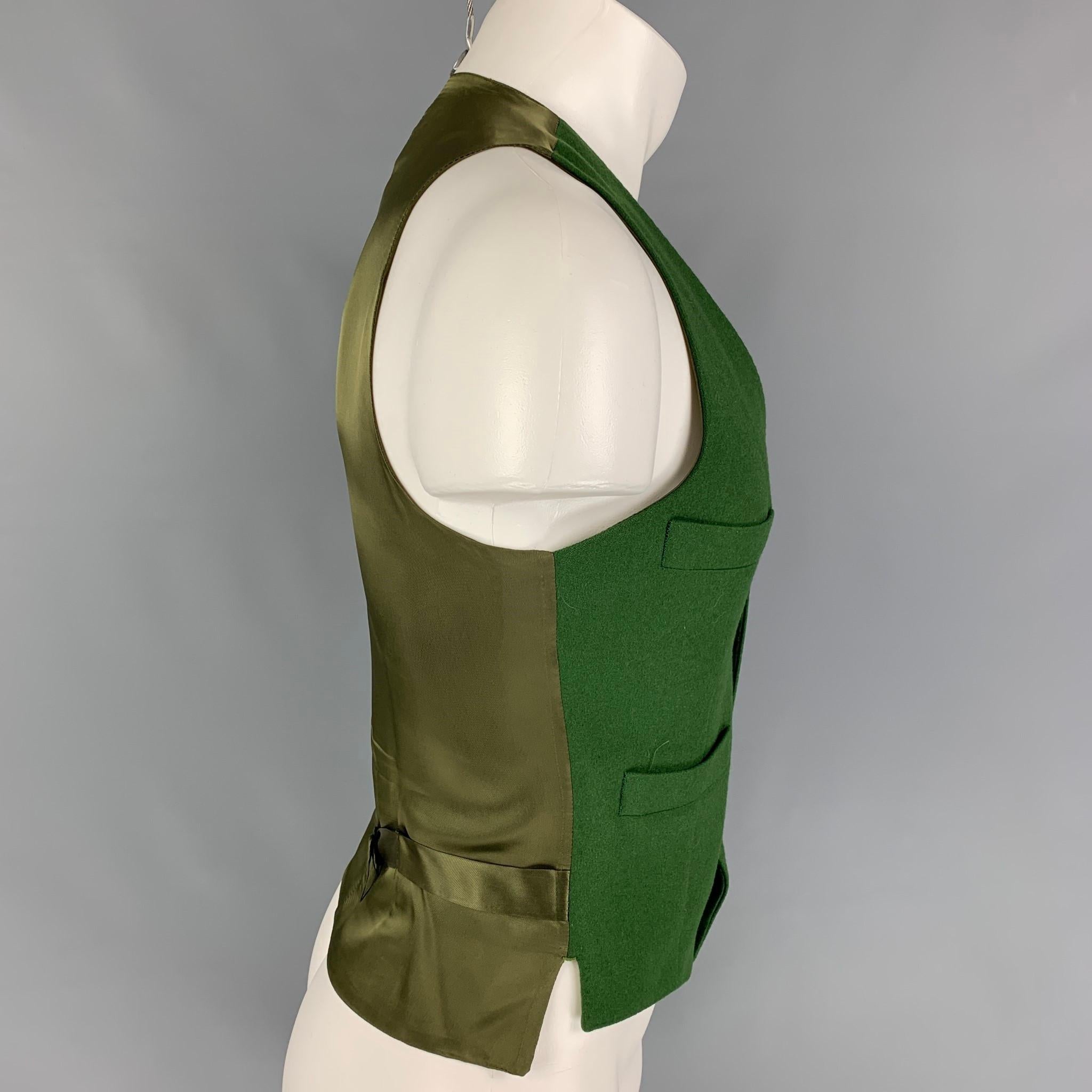 BENJAMIN BIXBY vest comes in a green wool featuring a back belt, slit pockets, and a buttoned closure. Made in Italy. 

Very Good Pre-Owned Condition.
Marked: 36

Measurements:

Shoulder: 11.5 in.
Chest: 36 in.
Length: 22 in. 