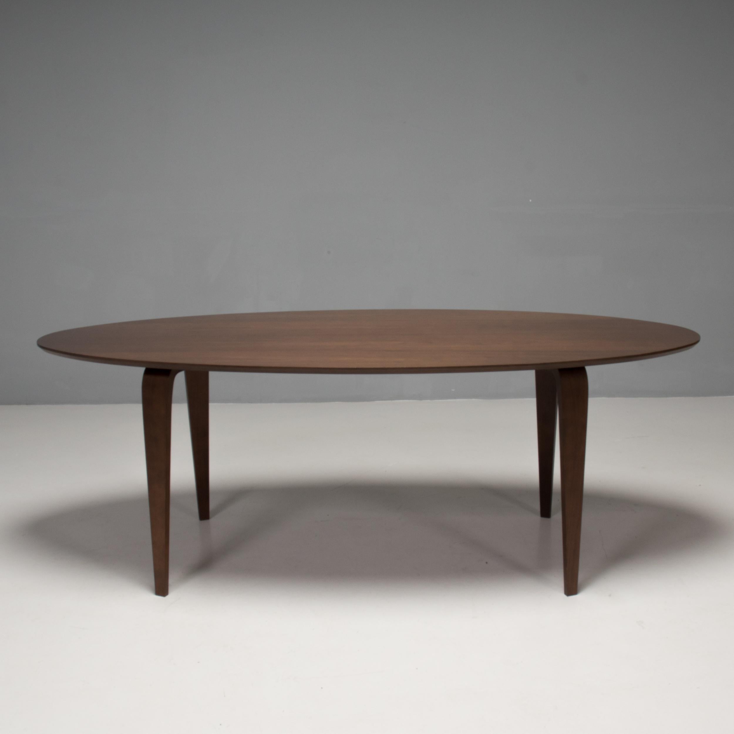 Originally designed by Benjamin Cherner in 2003, this Oval dining table was manufactured by the Cherner company in 2013.

Inspired by the curves of the original Cherner chair, this dining table is constructed from moulded plywood with a walnut