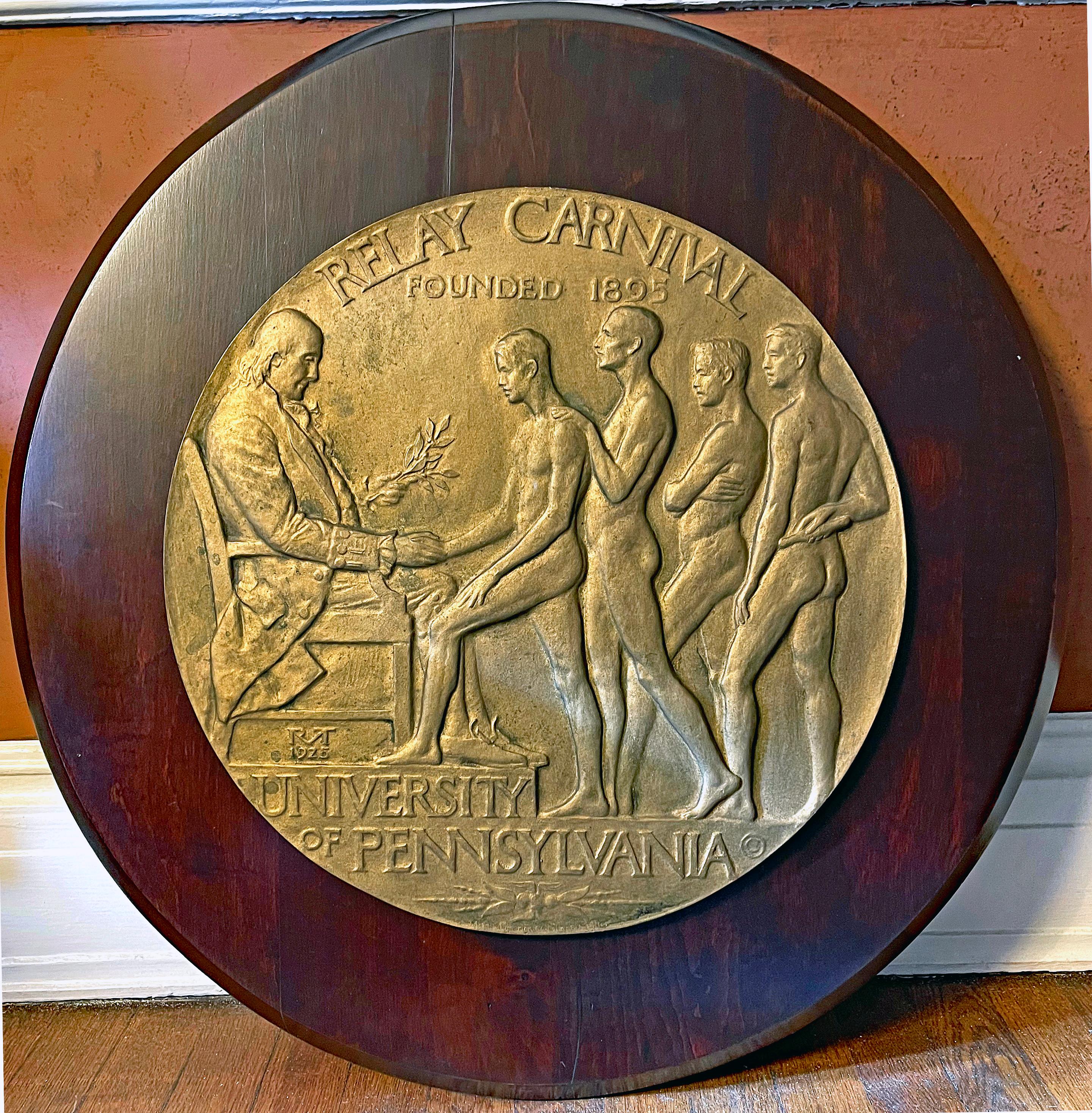 Extraordinary in size and subject matter, this monumental bronze relief sculpture, dating from 1925, depicts four nude athletes receiving the victory laurel from a seated Benjamin Franklin, founder of the University of Pennsylvania.  Franklin is