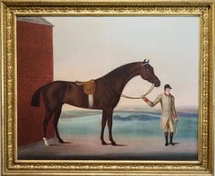 A dark bay racehorse held by his trainer at Newmarket Heath