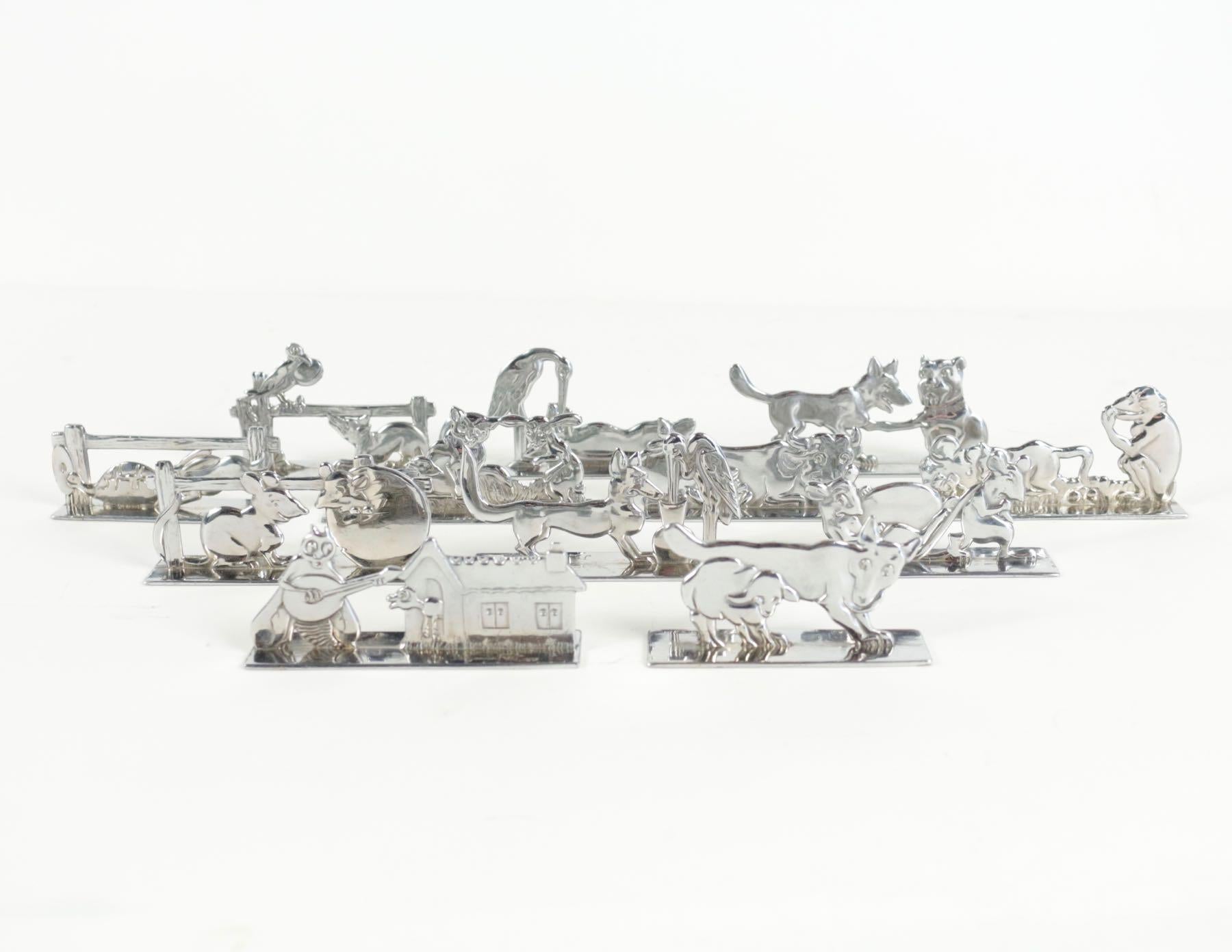 Benjamin Rabier Armand (1869-1939)
Rare service of six knife rests in silver metal, signed by the prestigious artist Benjamin Rabier and the silversmith Pierre Devouge. 
 Boxed set of animalier knife rests, (12) 
Date : circa 1925
Comprising
