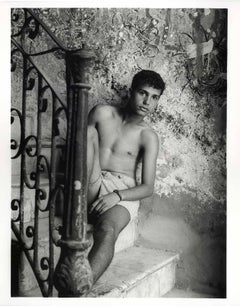 Jose, Cuba (shirtless teen boy in elegantly decadent architectural stairway)