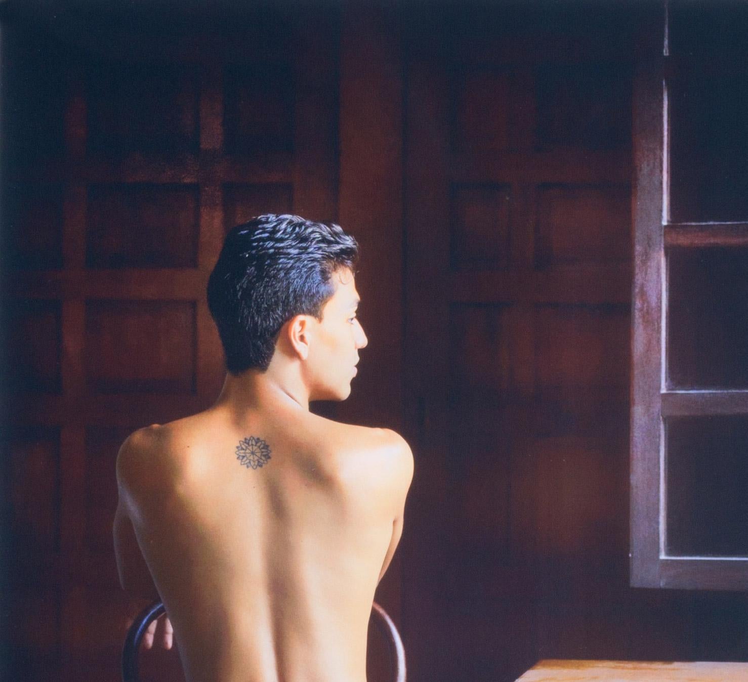 Looking Out (nude male Bel Ami model in Colombia seated in old colonial house) - Photograph by Benno Thoma