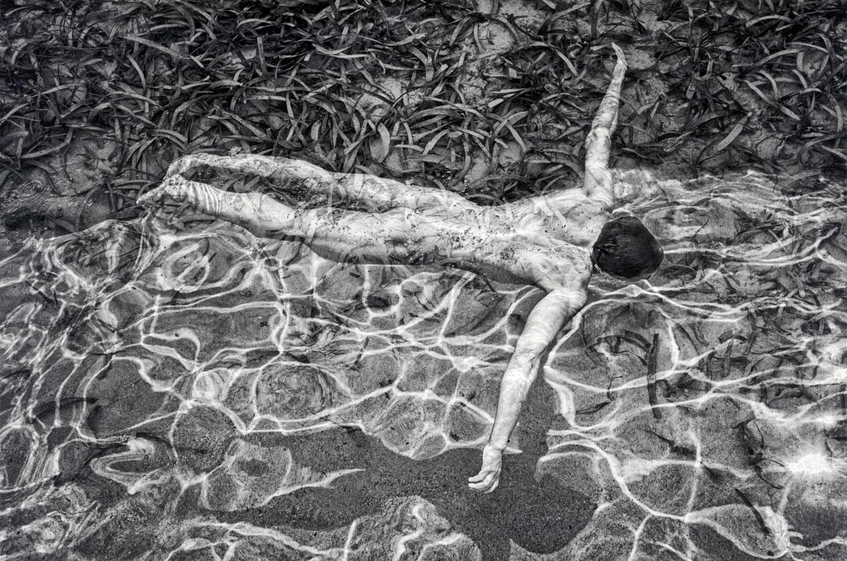 Benno Thoma Nude Photograph - Swimming (Sensual nude male relaxes in the water  on a sunny day)