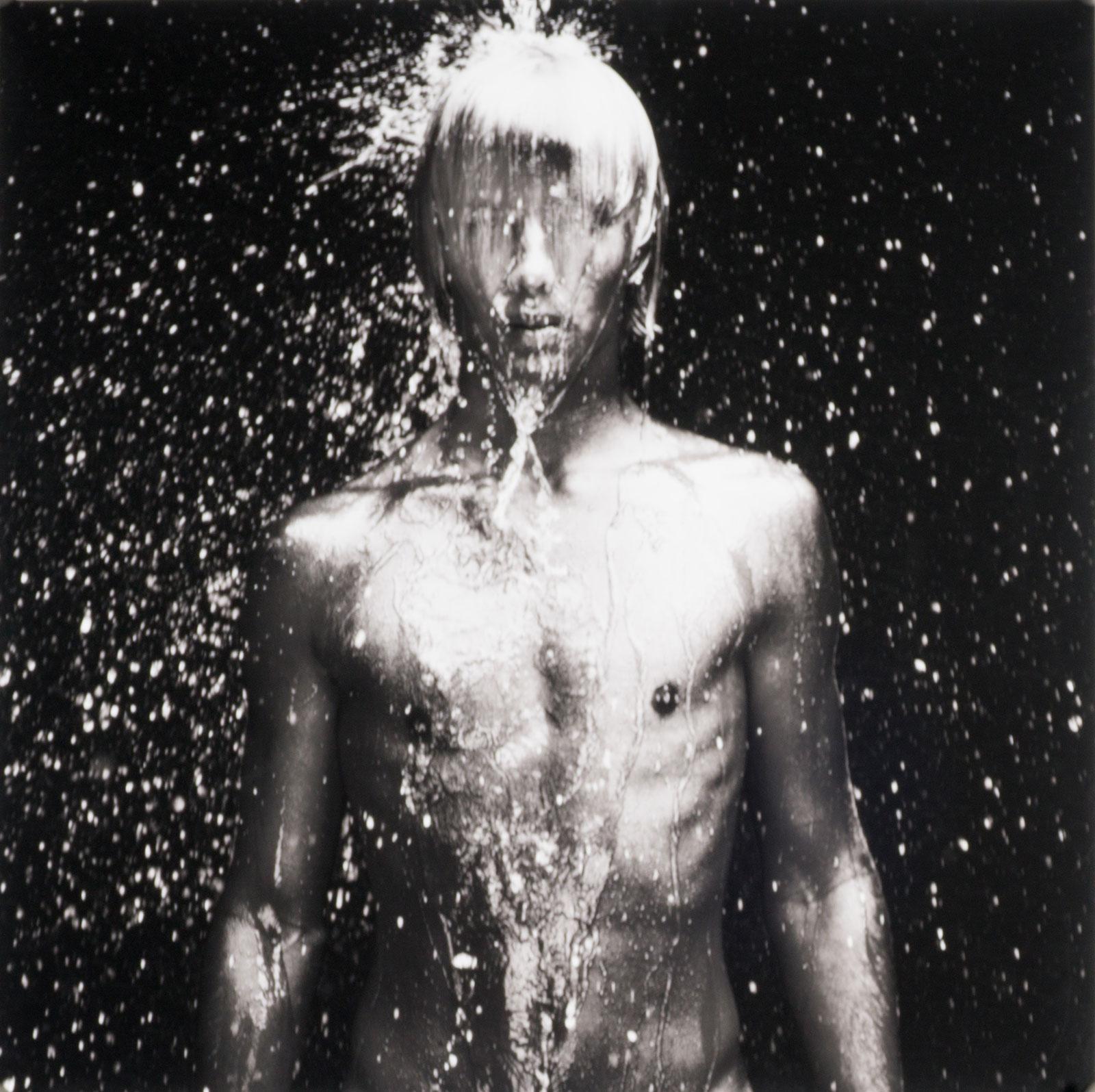 Benno Thoma Black and White Photograph - WET 11 (young nude Dutch boy being doused by droplets of water)